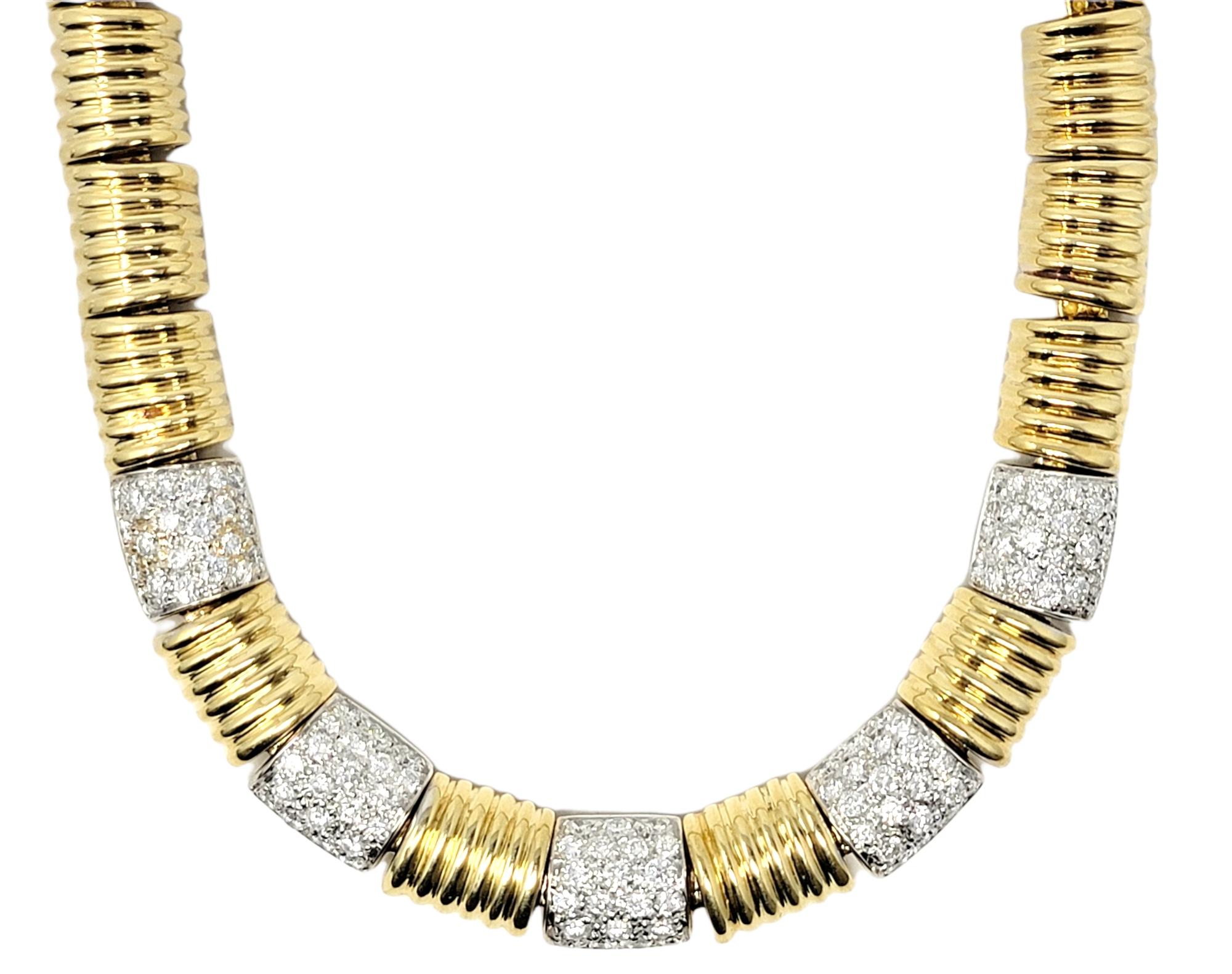Simple yet incredibly elegant gold and diamond choker style necklace. This gorgeous necklace features a series of heavy, polished yellow gold chunky ridged links arranged in a single row.  At the center of the necklace are 5 white gold links