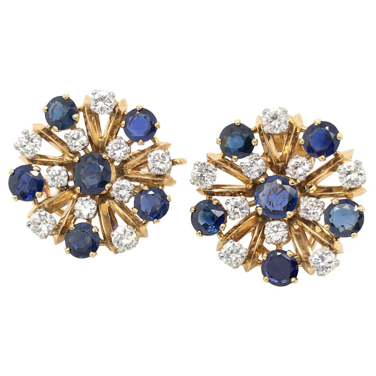 Wow, how beautiful are these earrings? They are absolutely gorgeous with their diamond and sapphire star motif or depending on how you look at them they could be a snowflake. 
Mounted in 18k yellow gold the claw set sapphires are a rich deep blue,
