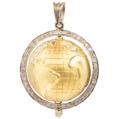18 Karat Yellow and White Gold Spinning Globe with Diamond Halo