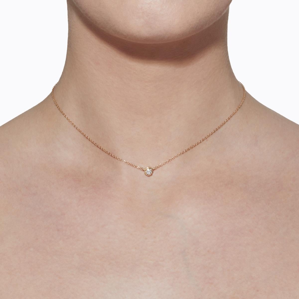 A single stone diamond necklace. Unlike traditional chain and pendant necklaces with a separate clasp, the diamond setting itself doubles as a hidden clasp, ensuring the stone is always featured in the front. Turn it horizontally 45 degrees to open