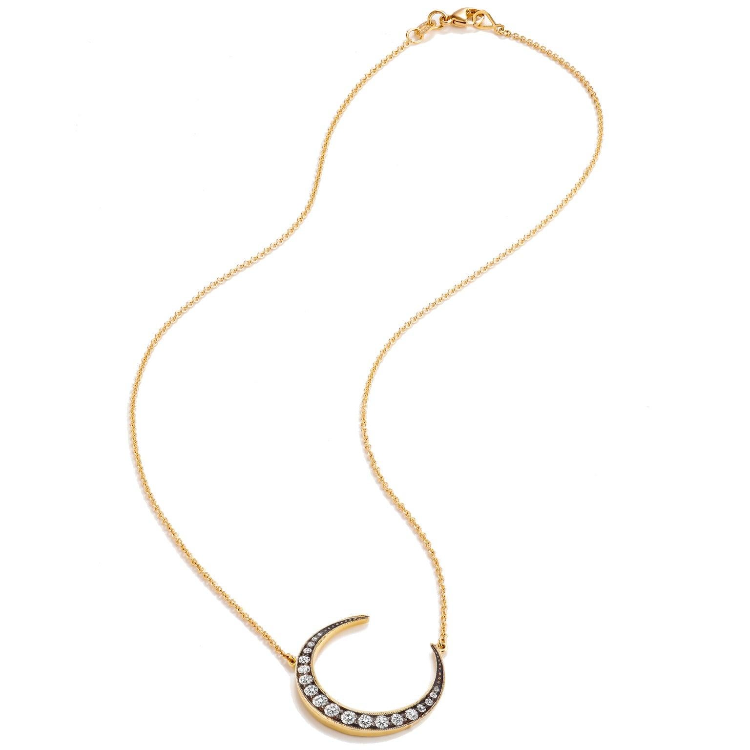 0.43 carat of pave-set diamond expand the surface of this crescent moon pendant strung on 18 karat yellow gold chain. A piece one can't help but gravitate toward.
