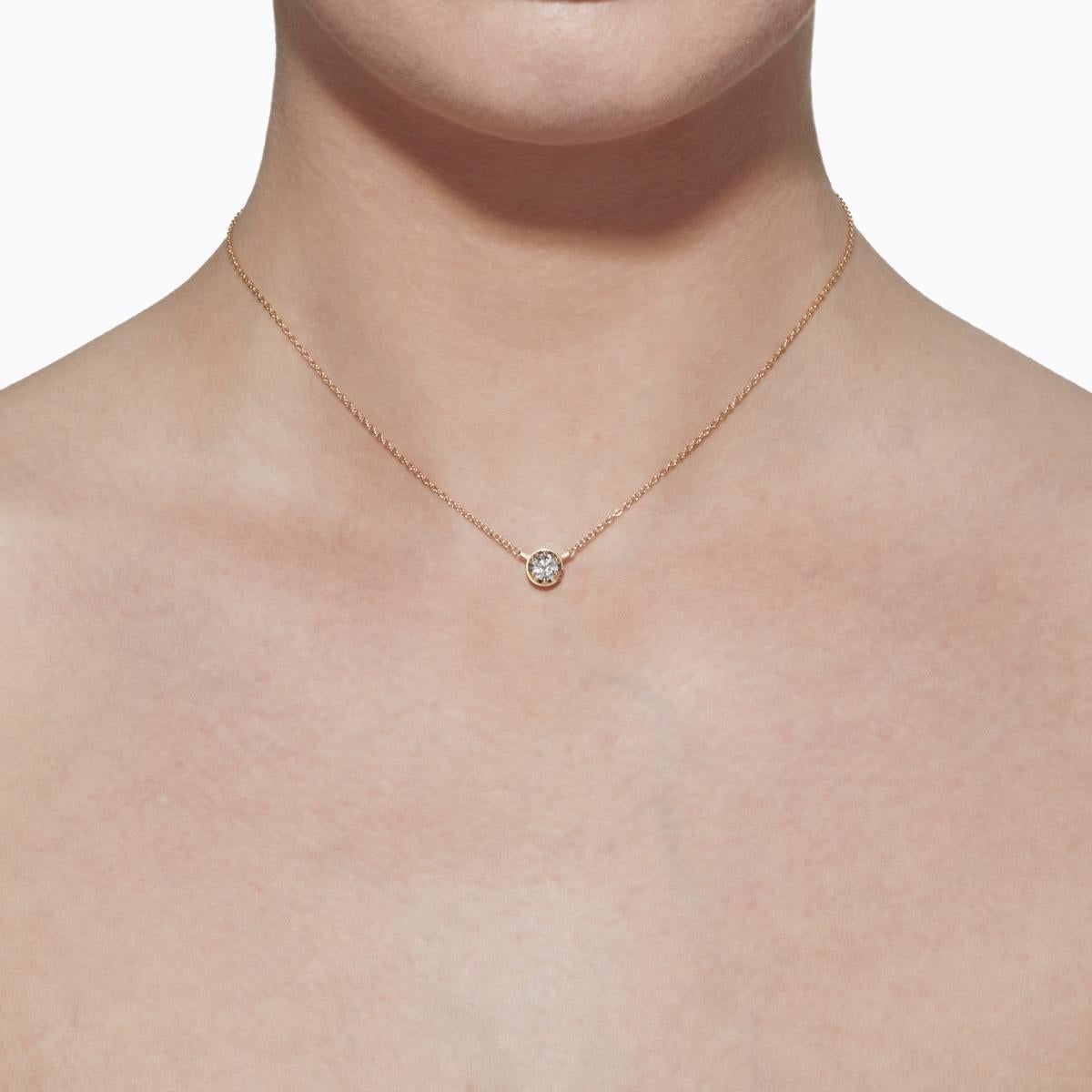 A single stone diamond necklace. Unlike traditional chain and pendant necklaces with a separate clasp, the diamond setting itself doubles as a hidden clasp, ensuring the stone is always featured in the front. Turn it horizontally 45 degrees to open