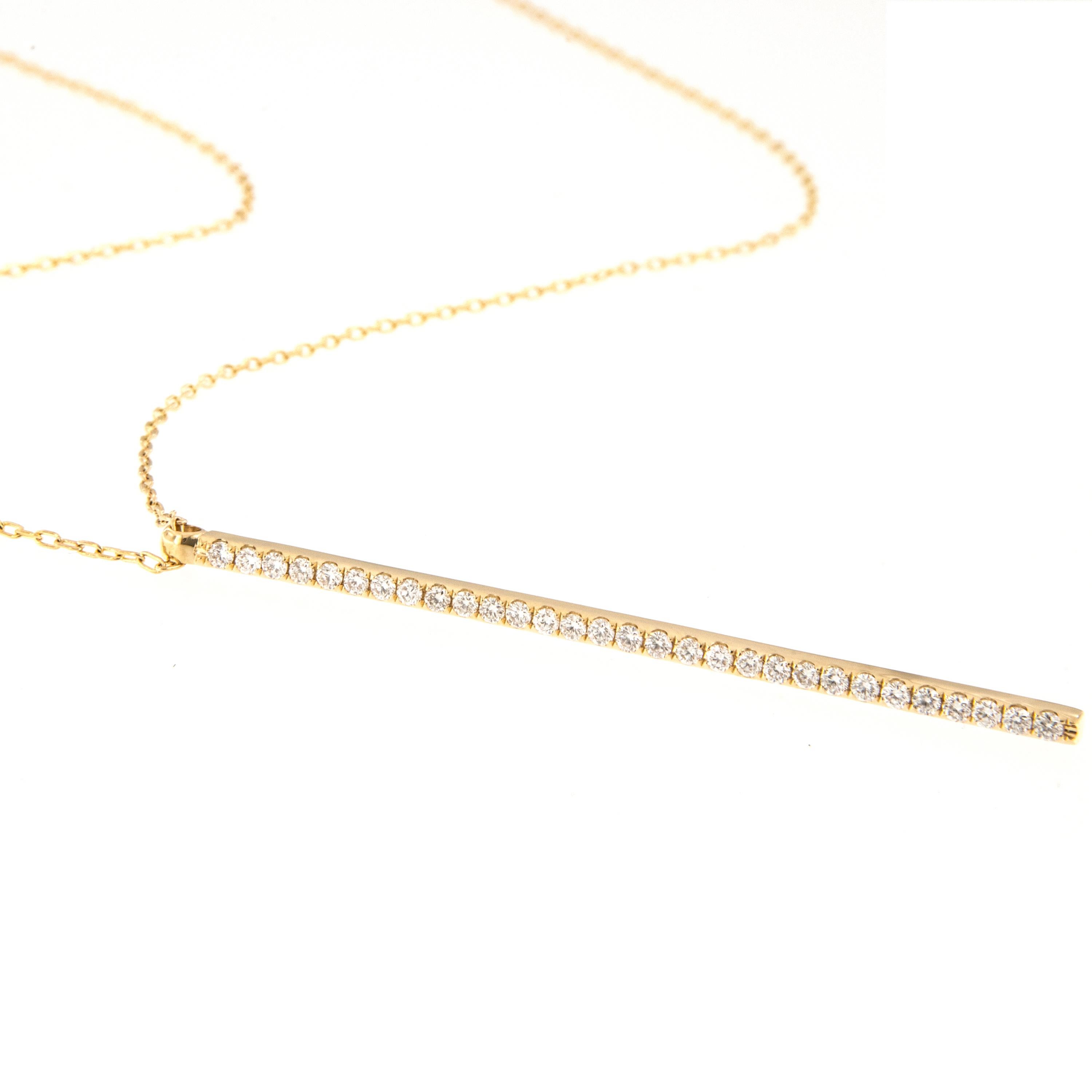 Crafted in rich 18 karat yellow gold, this fashion forward diamond drop necklace is sure to please! With 0.60 Cttw of fine VS diamonds shimmering in the 57mm long bar on an 18