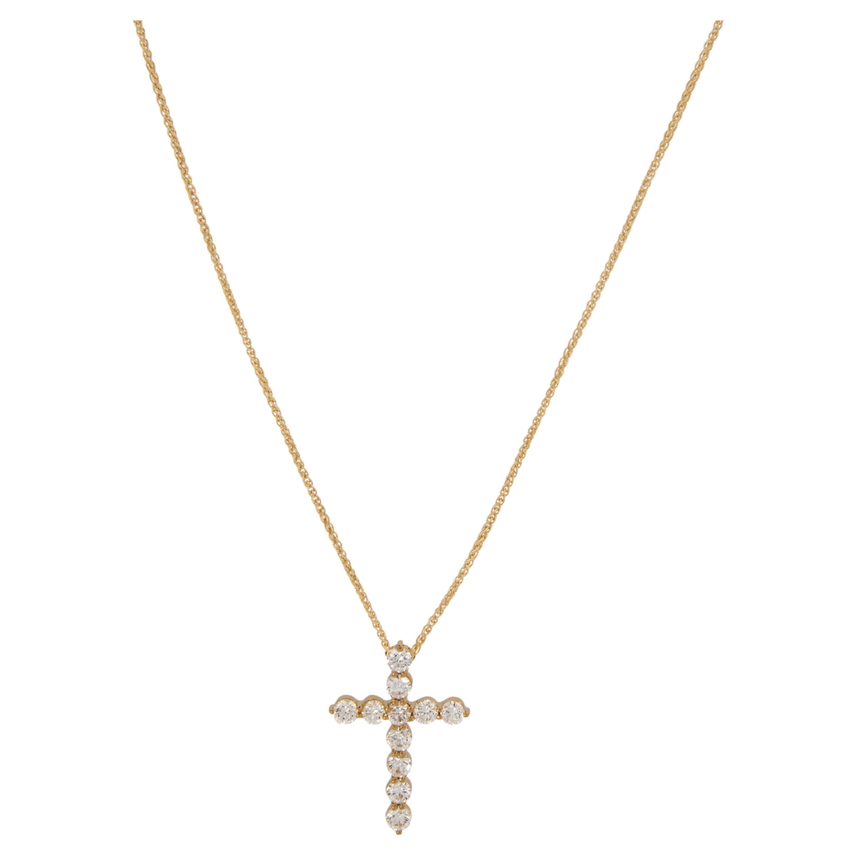 Made from rich 18 karat yellow gold and adorned with fine ( VS, G-H) quality diamonds = 0.82 Cttw. this elegant cross is the perfect addition to your wardrobe. Suspended on a sturdy 18