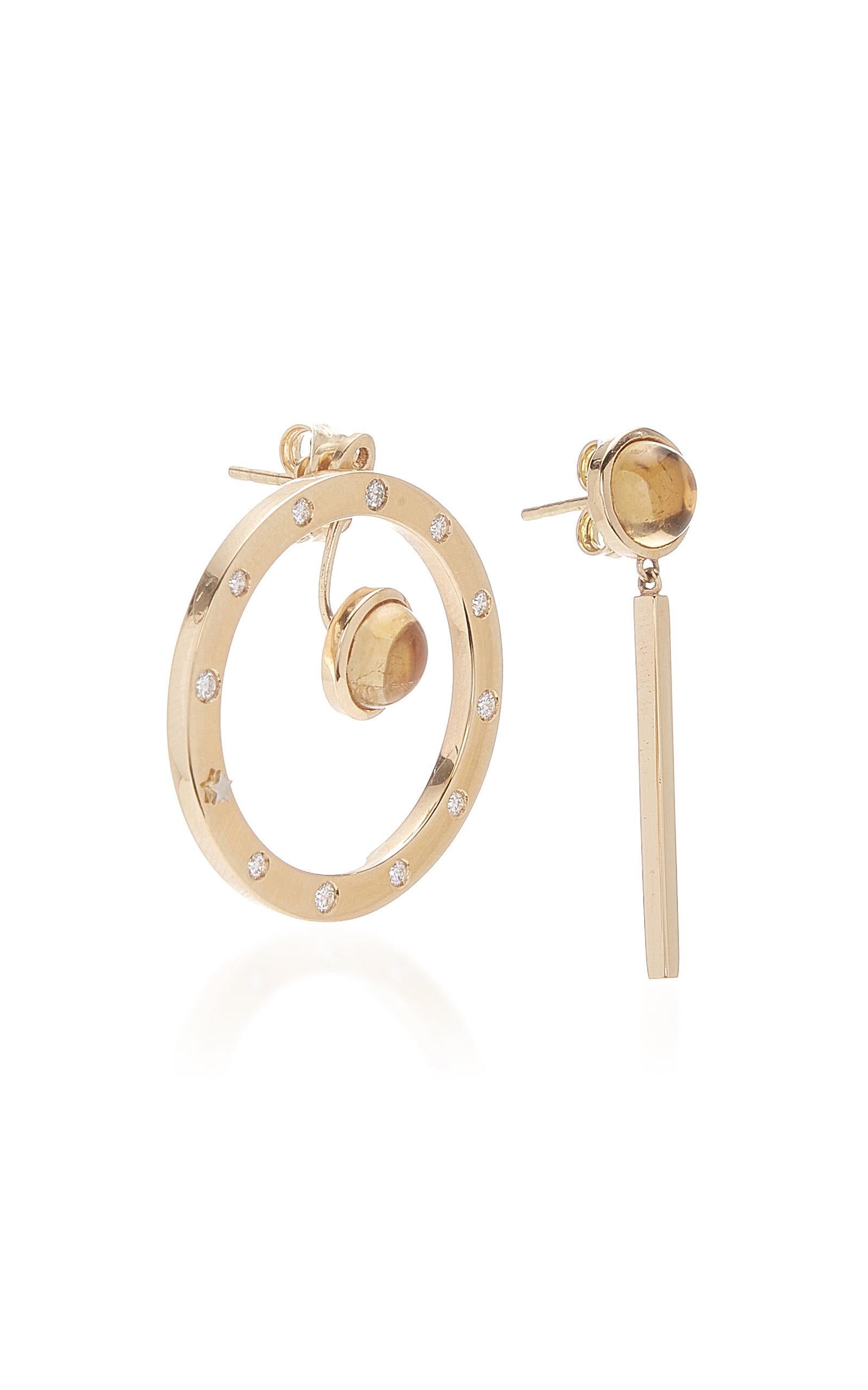 Inspired by the concept of time, Anna Maccieri Rossi's 'ORA Earrings' feature a mismatched pair with circular hoop and linear drop, both with citrine cabochons. The 11 white diamonds and a gold star at 8 o'clock around the hoop mark each hour of the