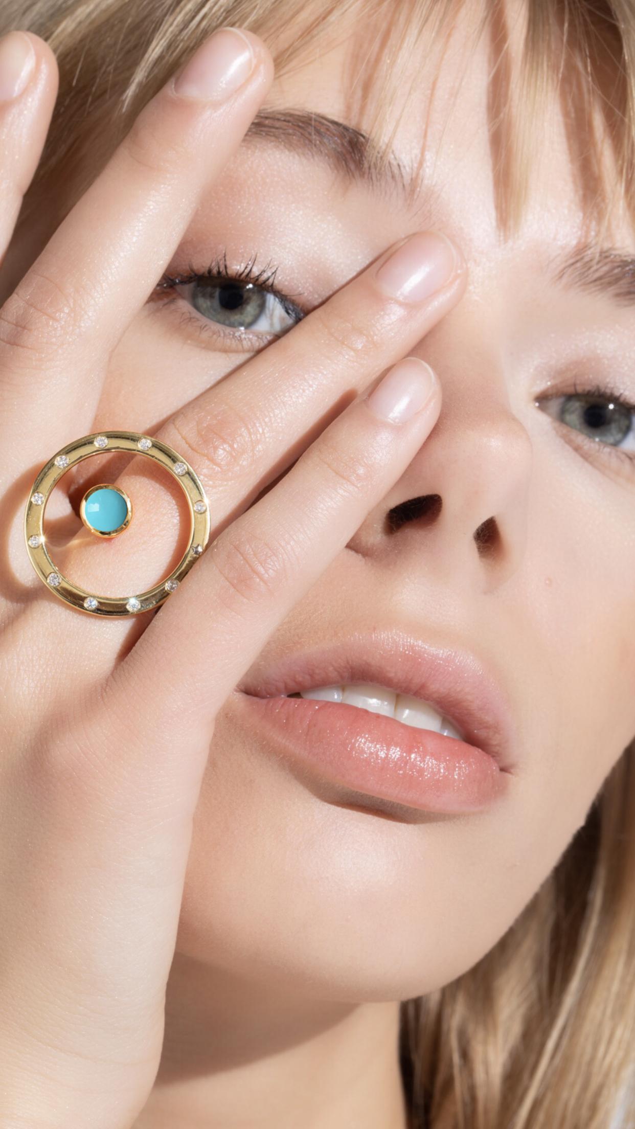 ORA Collection. 
Inspired by the concept of time, Anna Maccieri Rossi's 'ORA Ring' features a circular silhouette with turquoise cabochon at center. The hours of the day are marked by the 11 white diamonds and star at 8 o'clock around the