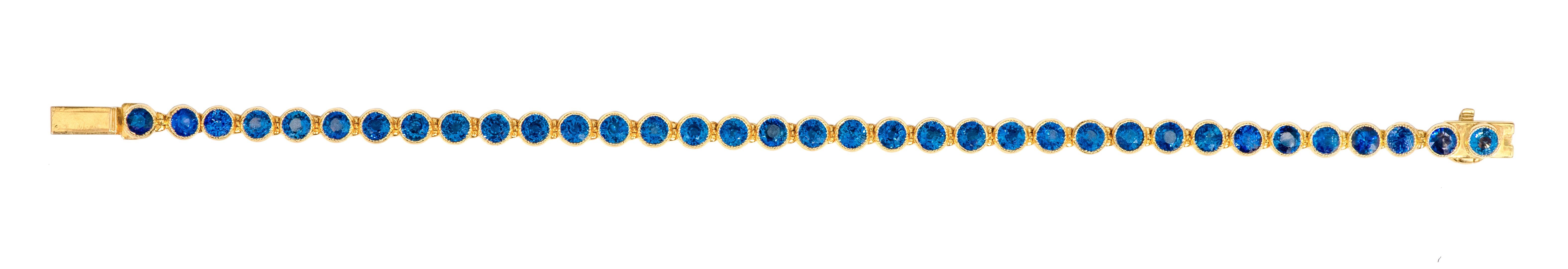 18 Karat Yellow Gold 11.72 Carat Blue Sapphire Tennis Bracelet in Bezel Setting

This fantastic royal blue sapphire tennis bracelet is timeless. The classic tennis bracelet with identical, perfect cut and crowned round blue sapphires in ideal bezel