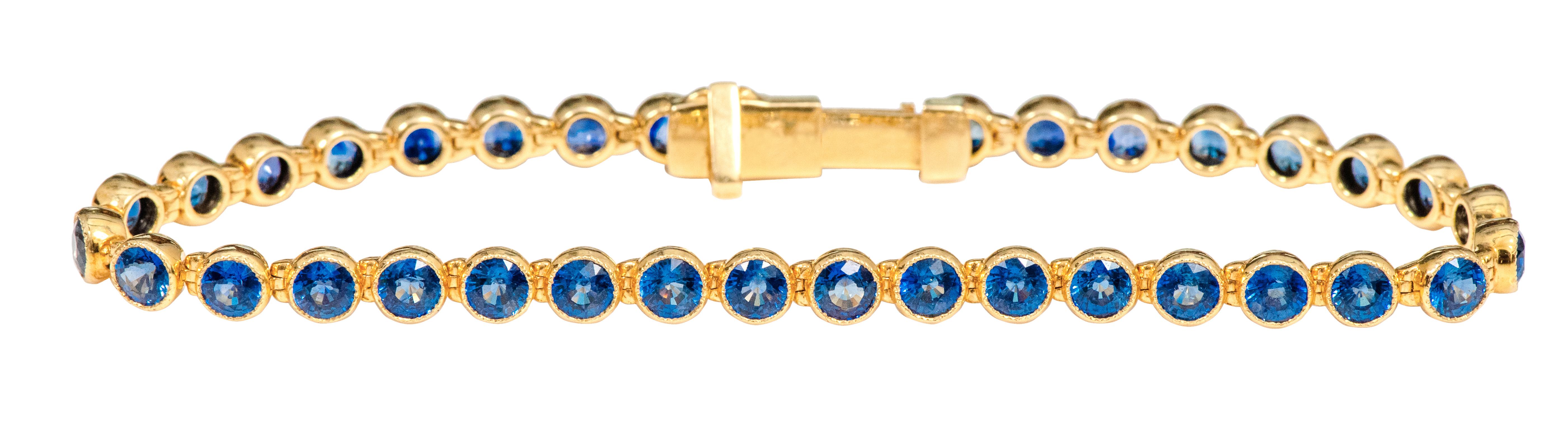 Round Cut 18 Karat Yellow Gold 11.72 Carat Blue Sapphire Tennis Bracelet in Bezel Setting