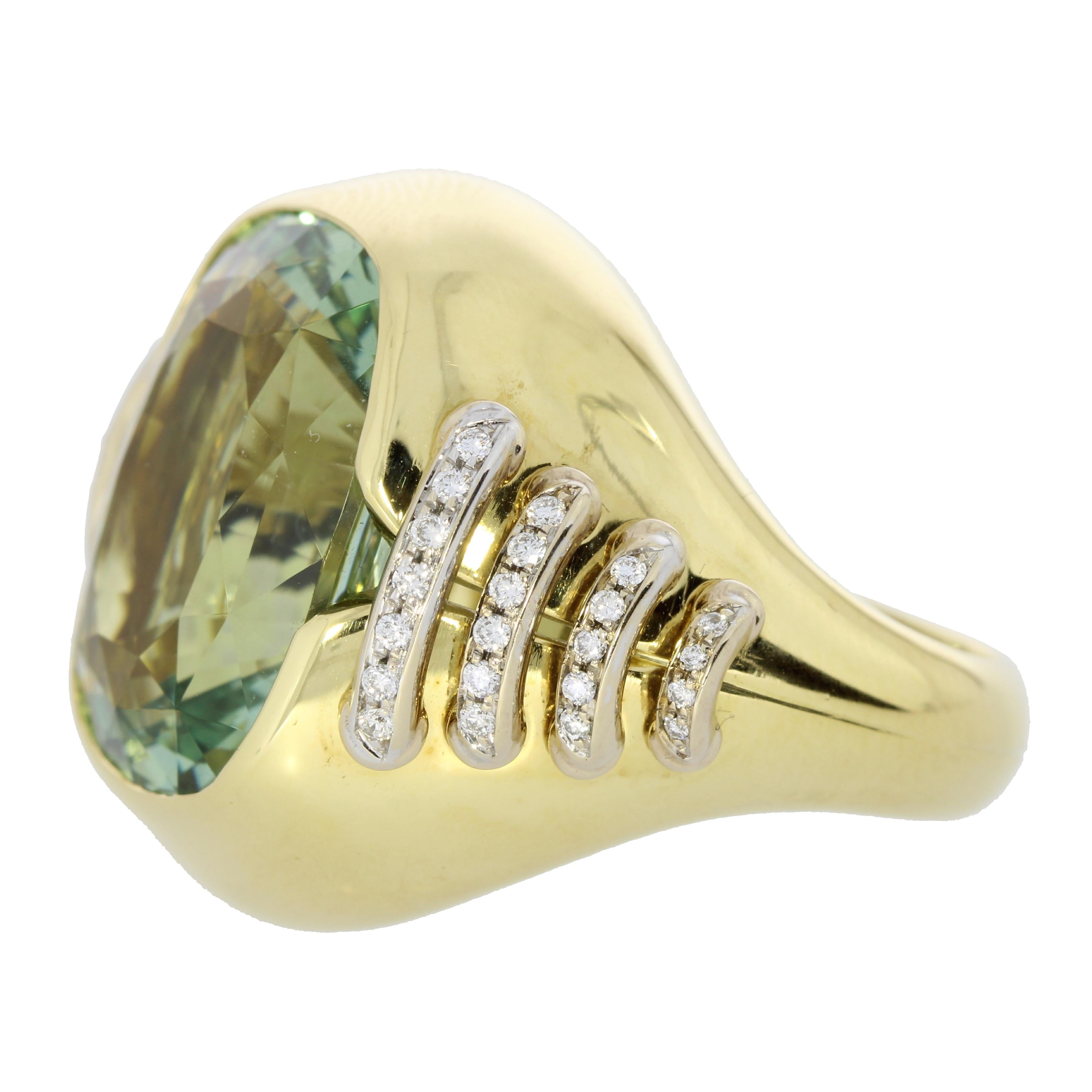 A stunning green aquamarine mounted in a contemporary cocktail ring held together by diamond laces crating a contemporary piece of art.

This Jewel is One of a Kind.

Details
- 18 karat Yellow Gold
- 14.08 carat Green Aquaqmarine
- 0.45 carat