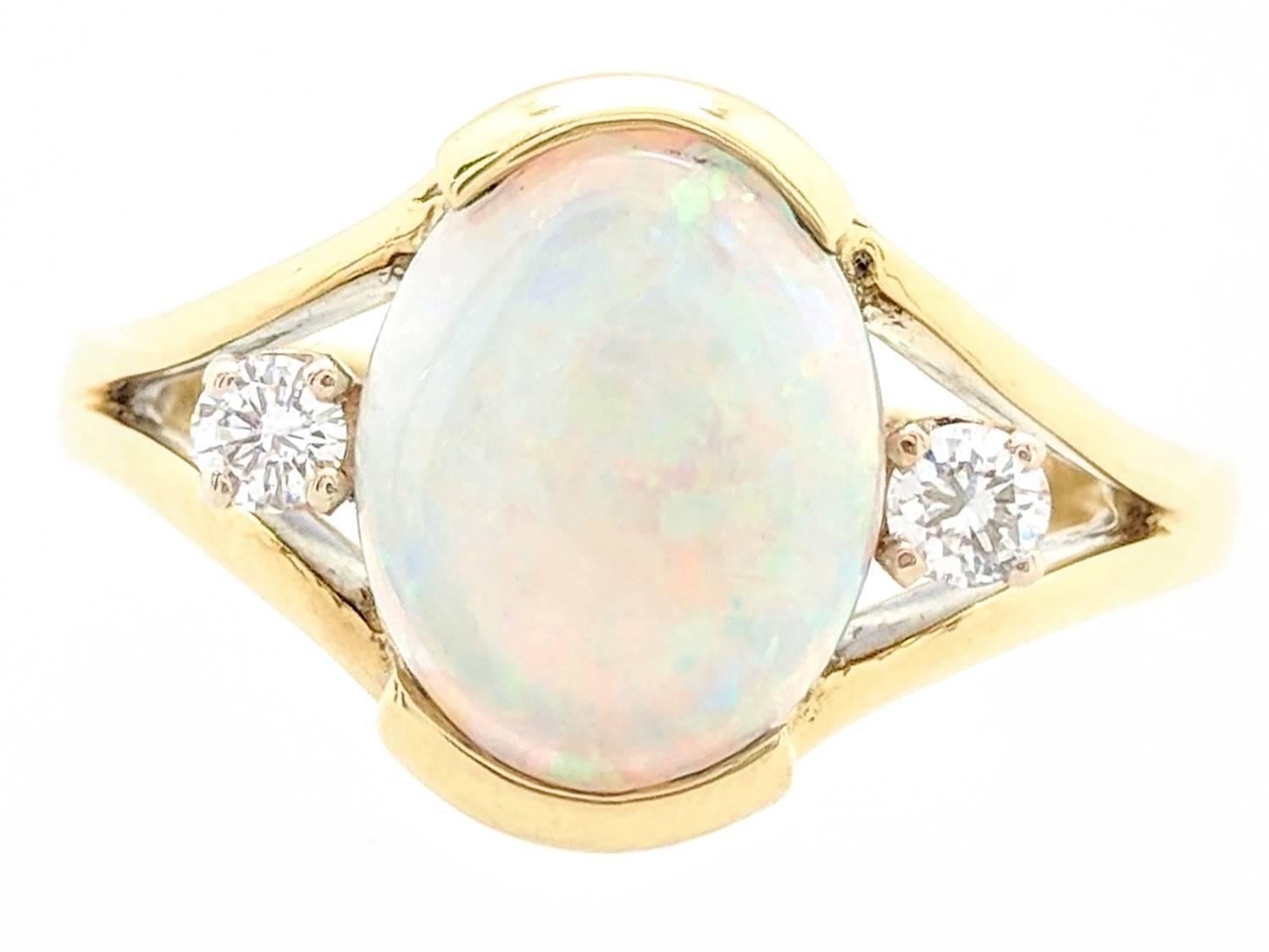 18k Yellow Gold 1.65ct Oval Shaped Natural Opal & Diamond Ring Size 5.5
Ring is crafted from 18k yellow gold and weighs 6 grams.  It features one (1) 1.65ct natural oval shaped opal and (2) .05ct natural round diamonds. This ring is currently a size