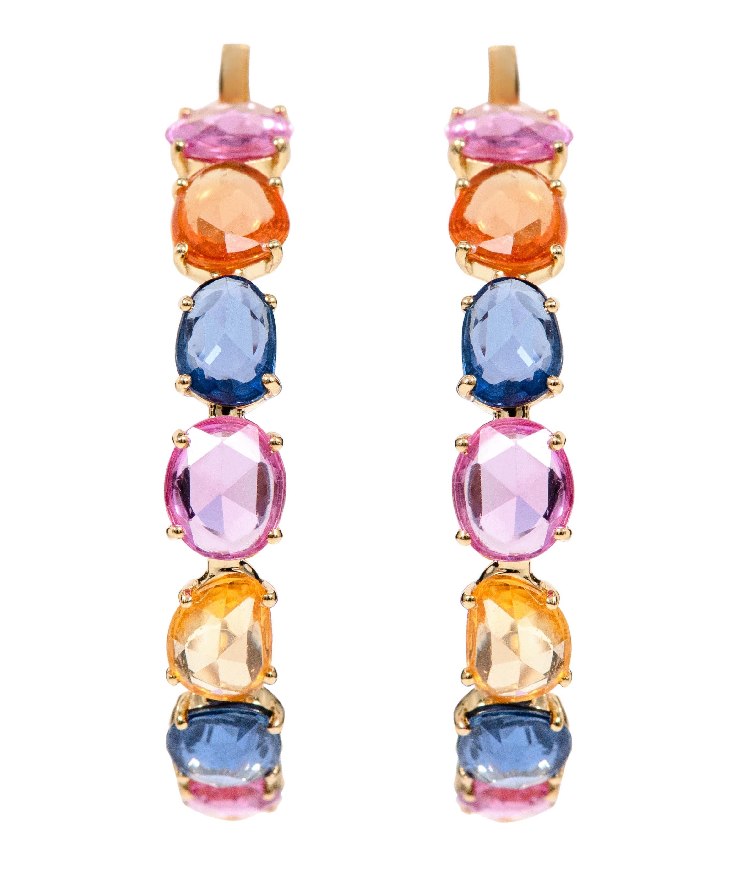 18 Karat Yellow Gold 17.42 Carat Multi-Color Sapphire Hoop Earrings 

The marvelous rainbow multi-sapphire full hoop is impressive. The solitaire uneven oval shape multi-sapphires in 4-prong yellow gold setting surround the hoop’s beauty to give a