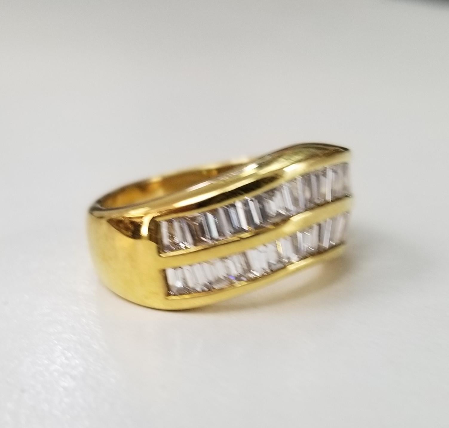 18 karat yellow gold 2 row diamond baguette channel set ring, containing 32 baguette cut diamonds of very fine quality weighing 1.50cts.  This ring is a size 5.5 but we will size to fit for free.