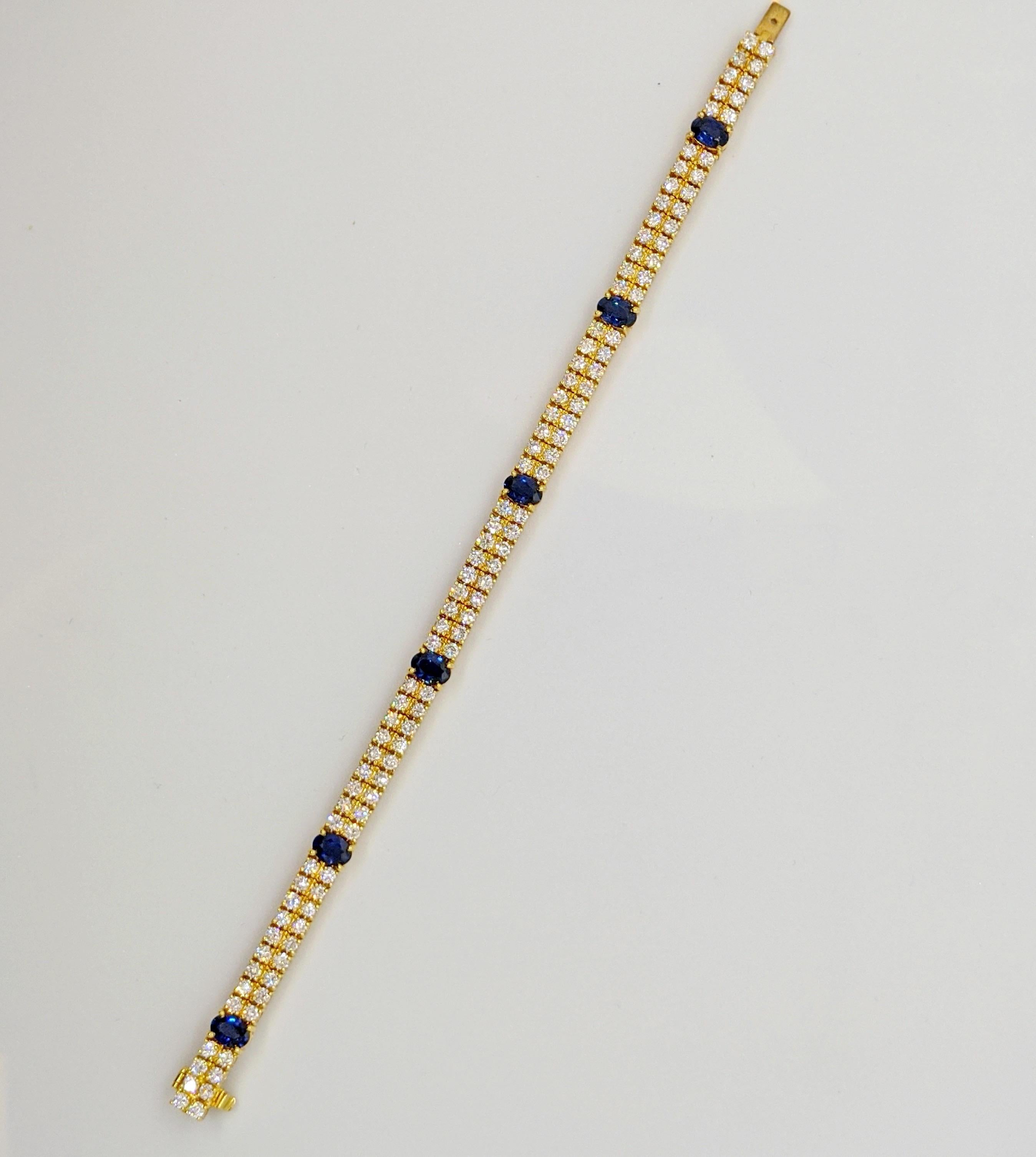 This is a beautiful classic diamond and sapphire bracelet. Set in 18 karat yellow god the bracelet features 2 rows of round brilliant diamonds. There are 6 oval blue sapphires evenly spaced throughout. The bracelet measures 7