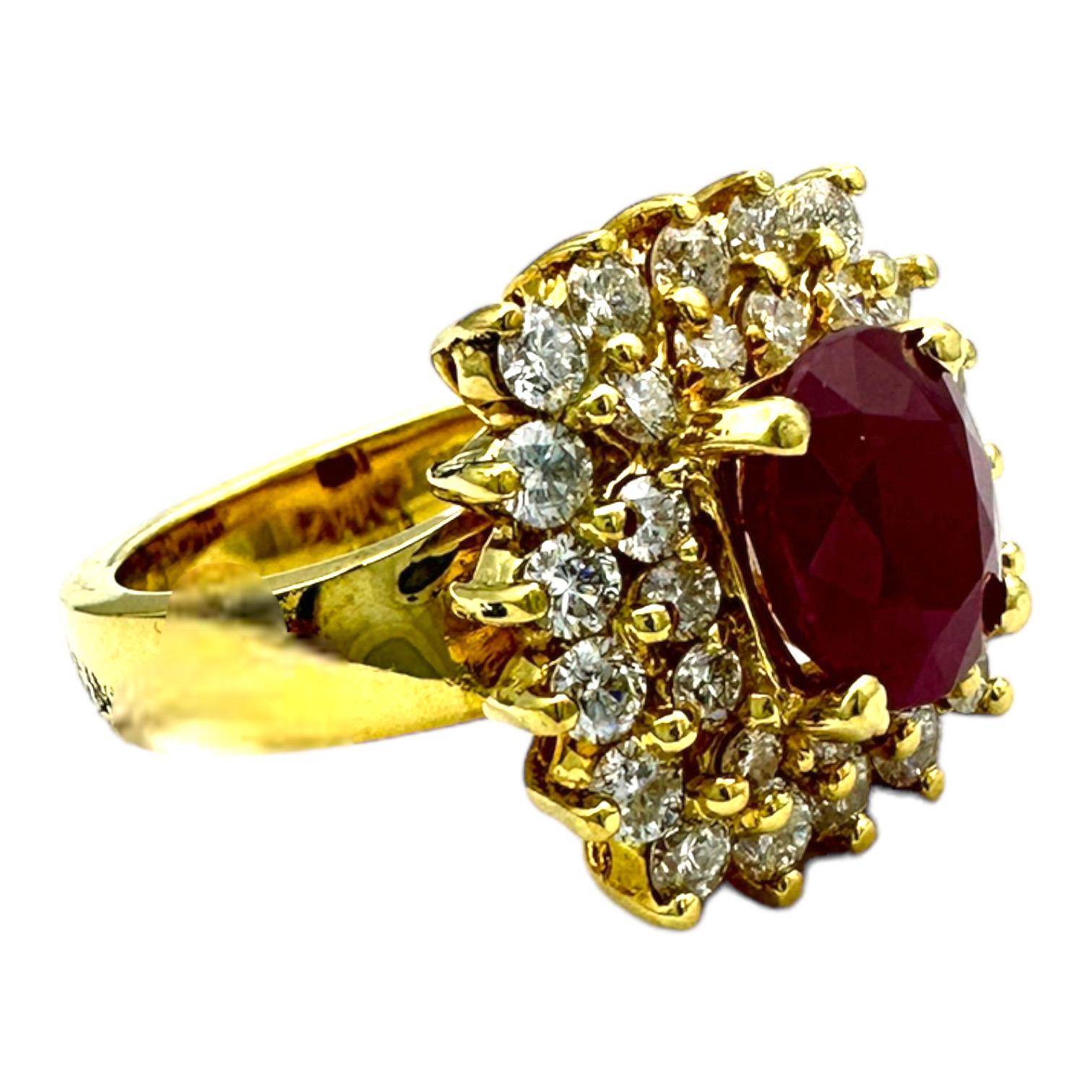 This captivating 18 karat yellow gold ring features a 2.10 karat Burma ruby surrounded by a striking diamond halo. The two outer halos surrounding the centrally-placed ruby create a timelessly elegant silhouette. Expertly crafted for lasting