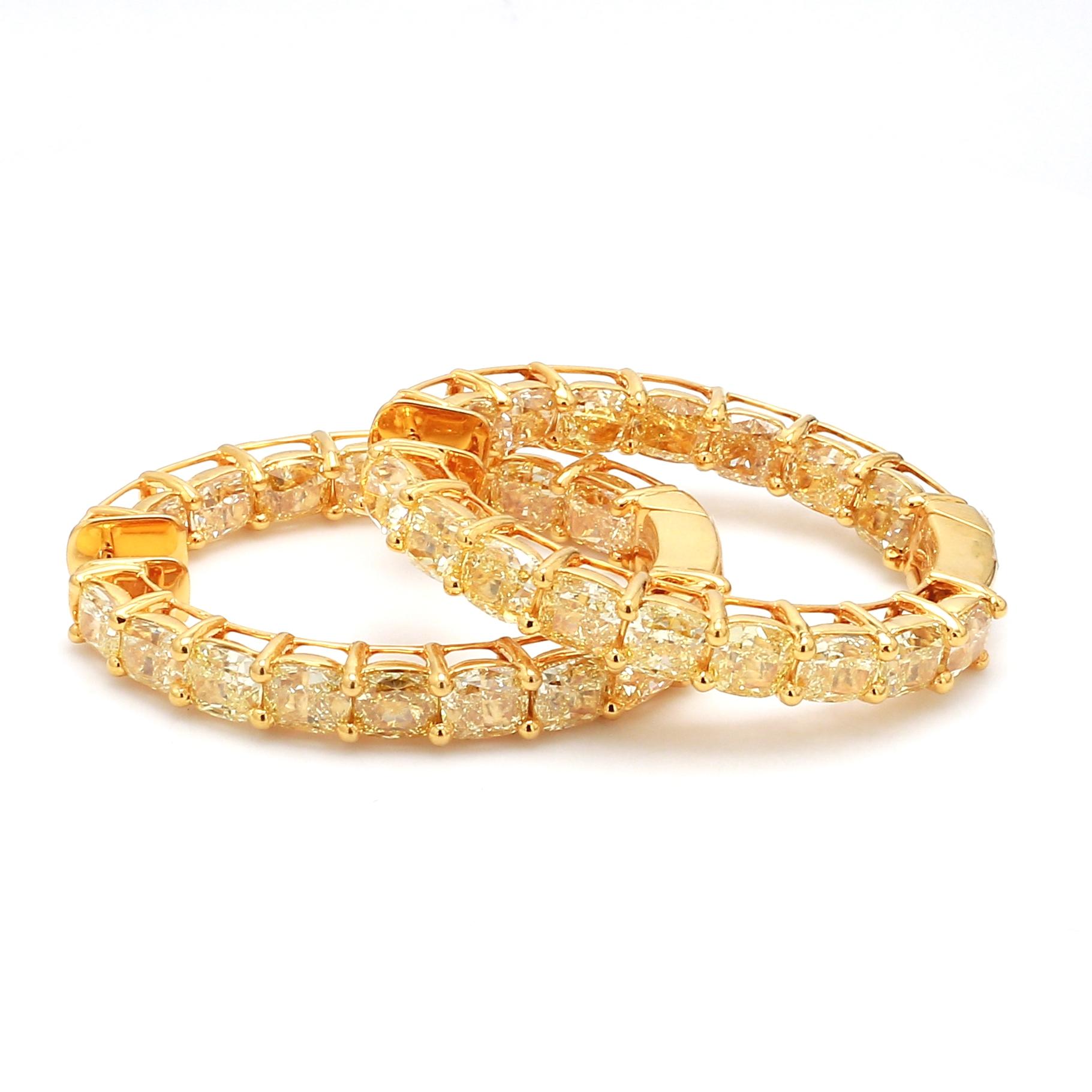 18 Karat Yellow Gold 21.76 Carat Fancy Yellow Diamond Hoop Earrings

The magnanimity of the glorious radiant cut comprising of 50 pointers each solitaire canary yellow diamonds in solid yellow gold eagle prong setting. The intensity of the fancy
