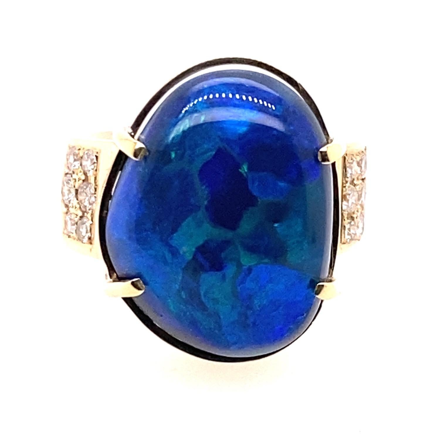 18 Karat Yellow Gold 23 Carat Australian Black Opal Diamond Cocktail Ring

Handmade 18kt yellow gold ring. The center stone is a solid 23 carat Australian black opal secured in four claw setting. Each shoulder has 6 round brilliant cut diamond in