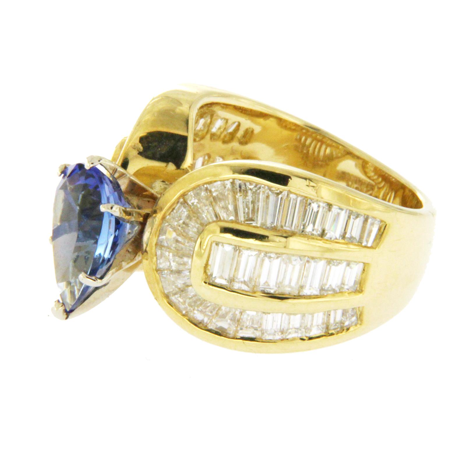 Top: 12.5 mm
Band Width: 5.5 mm
Metal: 18K Yellow Gold 
Size: Message us for size
Hallmarks: 18K
Total Weight: 16.6 Grams
Stone Type: 4.70 CT Natural Blue Tanzanite 2.60 CT G SI2 Diamonds
Condition: New
Estimated Retail Price: $9500
Stock Number: RF