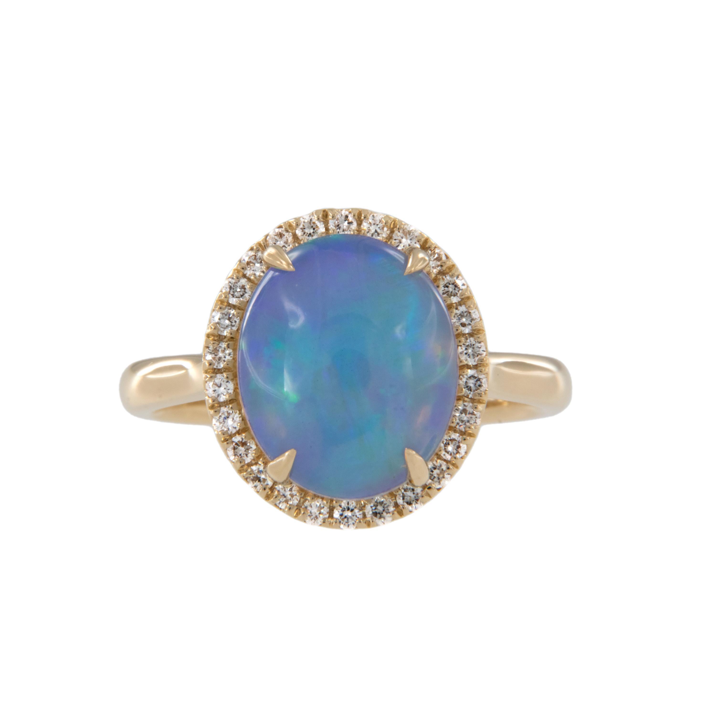 Breathtaking jelly opal with lovely blue and green play of color takes center stage in this enchanting ring! Made from rich 18 karat yellow gold with diamond halo = 0.26 Cttw. 2.60 Carat Opal is 12 x 10mm oval cabochon cut. Ring is a size 7 and is