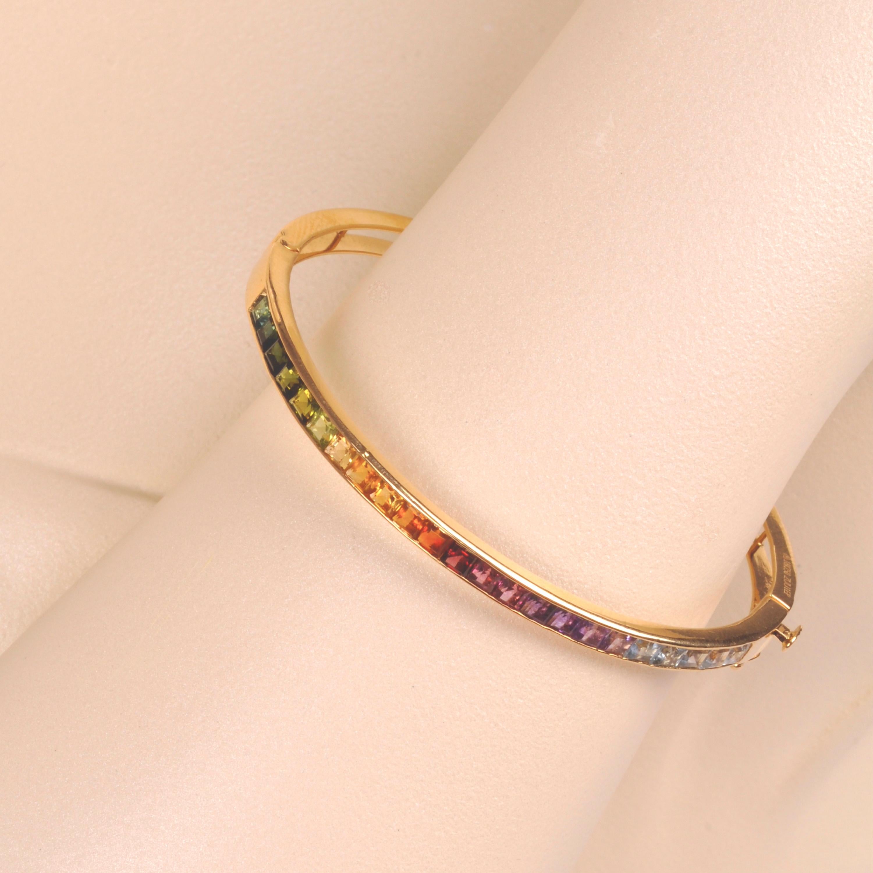 18 karat yellow gold 3mm square channel-set multicolor rainbow gemstone modern bracelet.

Discover the enchantment of the Multicolor Rainbow Channel Set Bracelet, a true embodiment of vibrant sophistication that celebrates nature's myriad of colors.