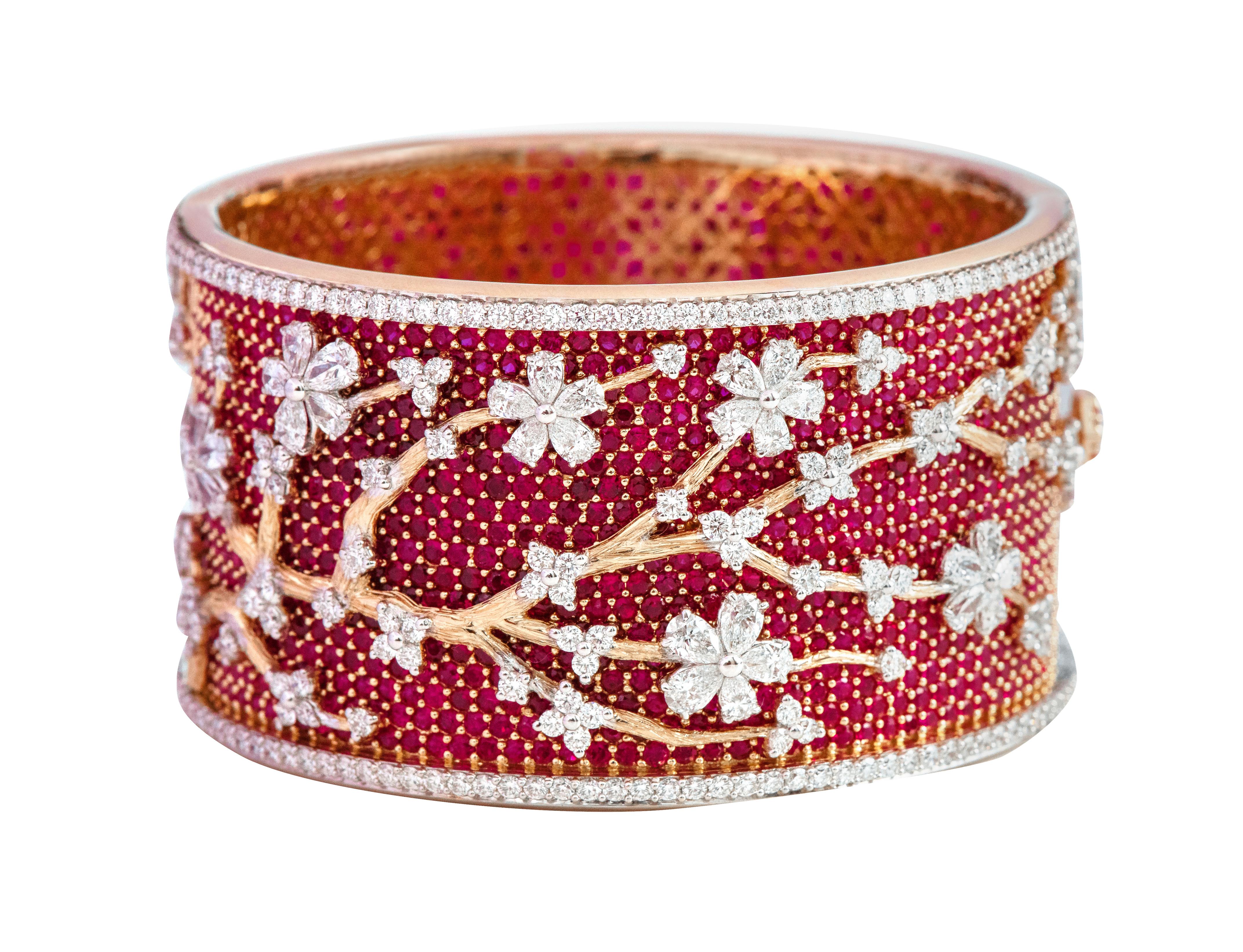 18 Karat Yellow Gold 49.80 Carats Ruby and Diamond Bangle in Contemporary Style 

This nouveau-style blood red ruby and diamond bangle is strikingly gorgeous. The pave set round ruby bed forms the intriguing base of the bangle with the hammered