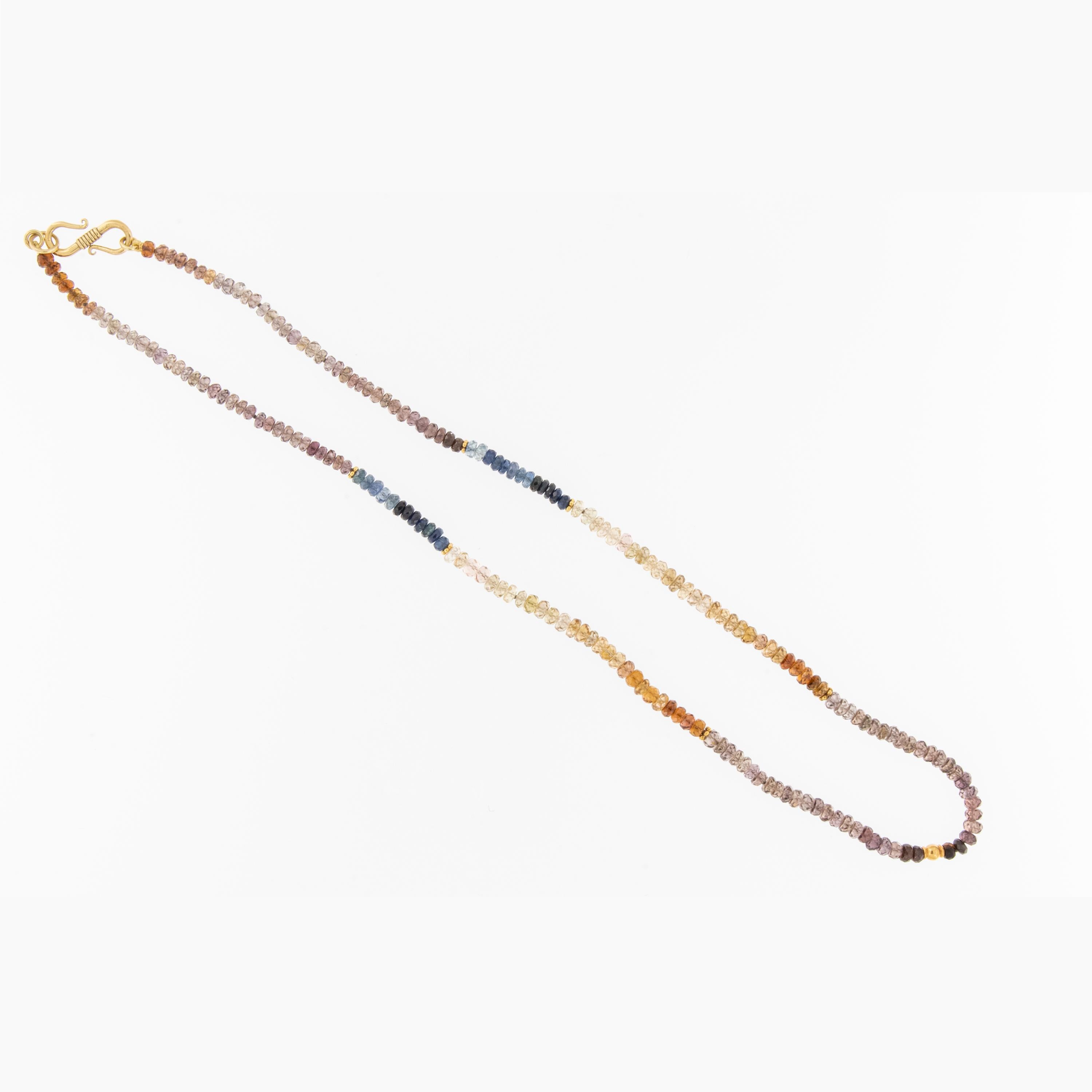 Beautiful and softly hued faceted sapphire beads are hand strung in ombre' fashion accented with 18 karat yellow gold station beads and is 16.375