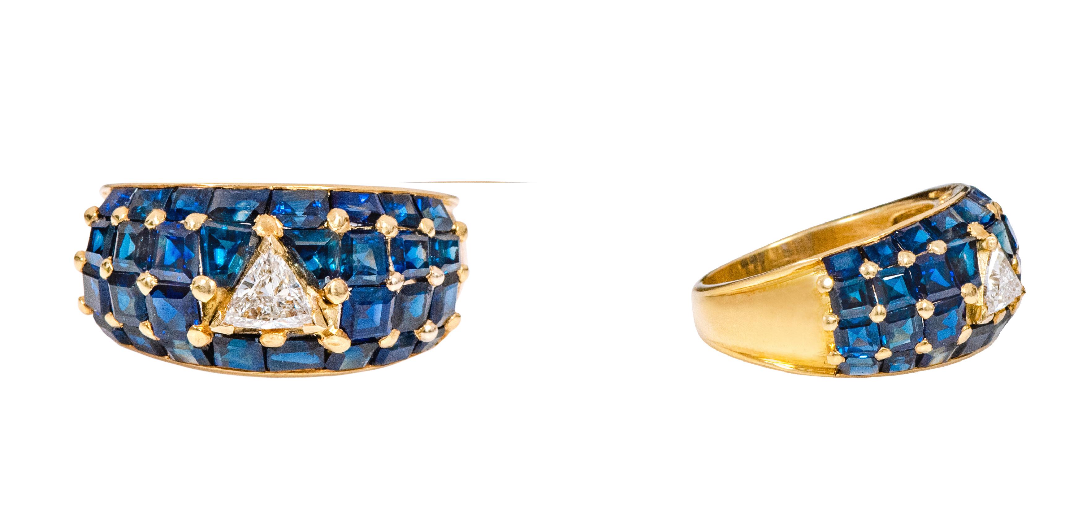 18 Karat Yellow Gold 6.20 Carat Diamond and Sapphire Statement Ring

This extraordinary royal blue sapphire and diamond broad band is glorious. The solitaire trillion shaped diamond in the center in V-prong setting is heightened with slightly