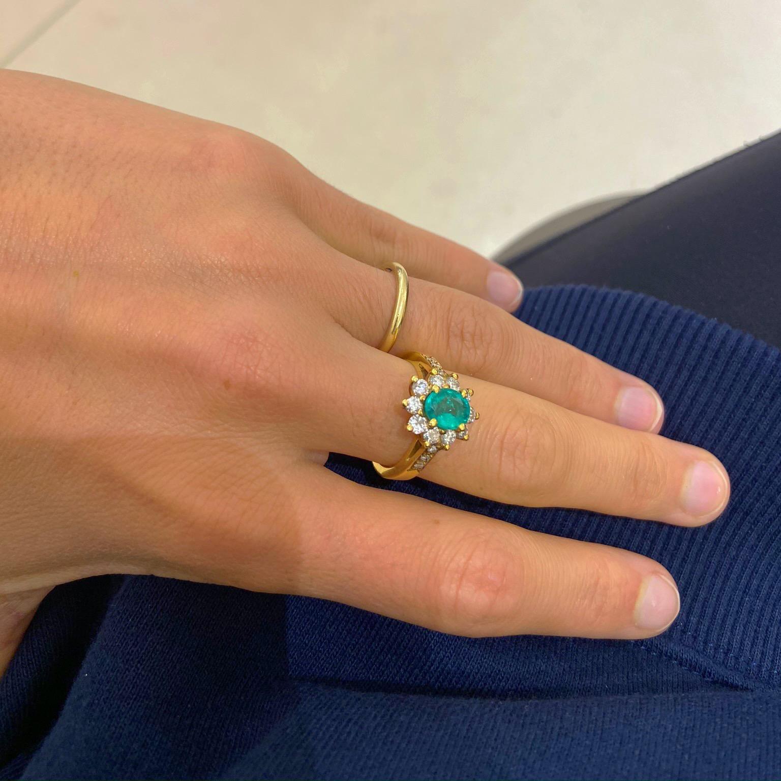 Set in 18 Karat Yellow Gold, is a beautiful .86Ct. Oval Emerald surrounded by .75Ct. of Round Diamonds set in a three prong setting. 
10 Diamonds totaling .75 Carats. 
Size: 6, Can be sized upon Request. 
Available at Cellini Jewelers NYC