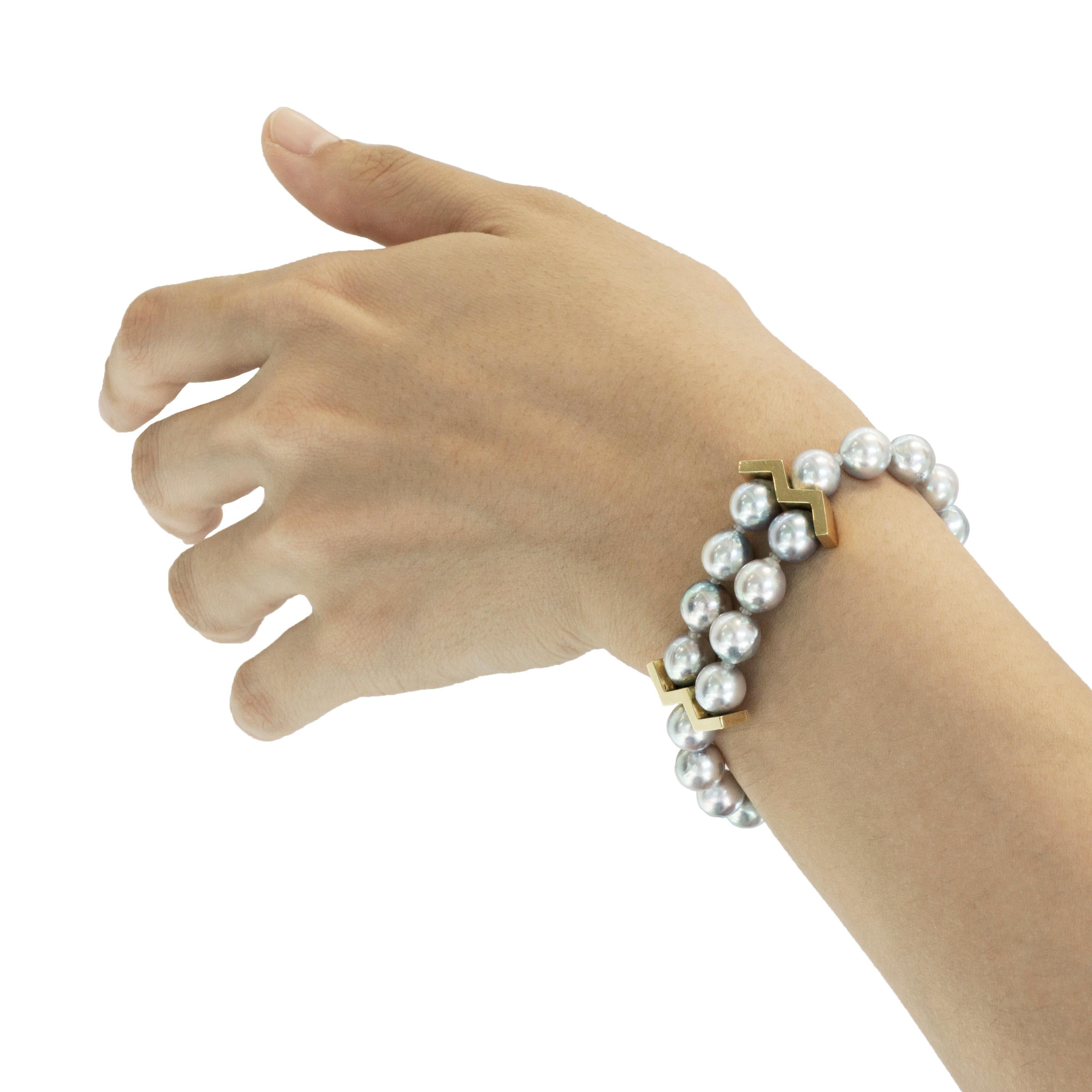 Elegant natural Akoya pearls of a stunning silver grey hue make  this unique bracelet. It features double strands in the center that graduate into one strand with the Madan signature M findings and a fully integrated 18 karat gold fish-hook clasp