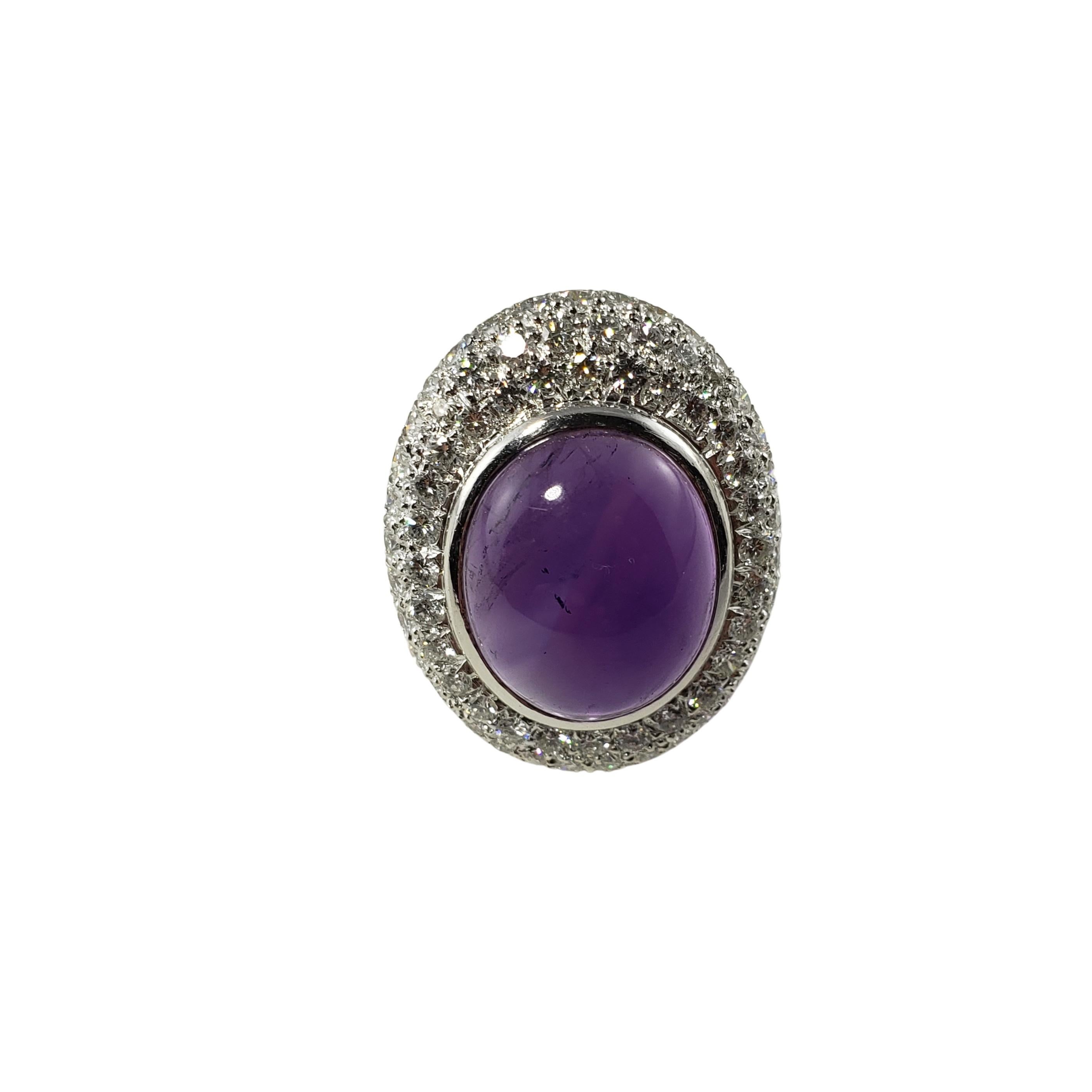 Vintage 18 Karat White Gold Amethyst and Diamond Ring Size 7.75 GAI Certified-

This stunning ring features one oval cabochon amethyst (17 mm x 15 mm) and 129 round brilliant cut diamonds set in meticulously detailed 18K white gold. Top of ring