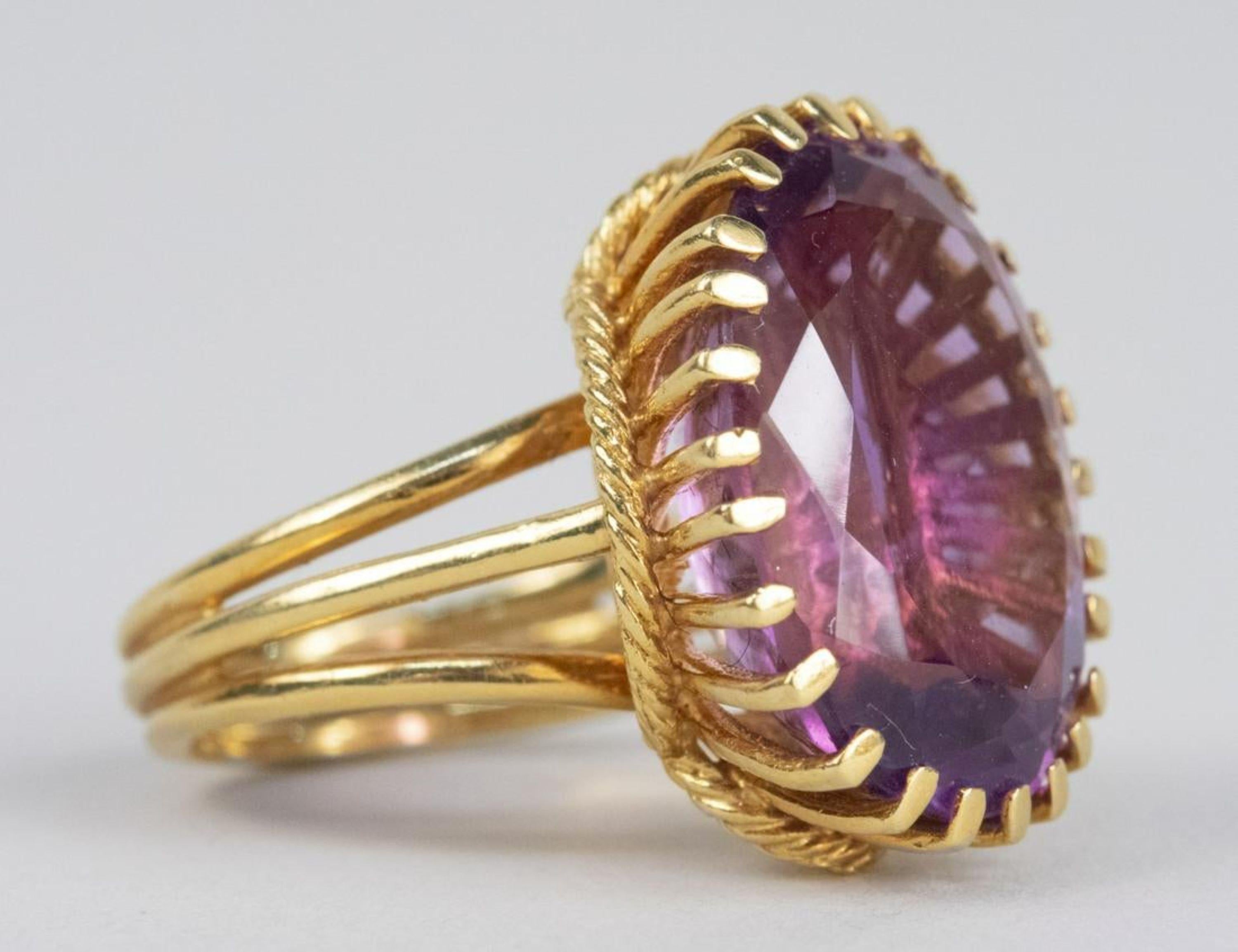 18K yellow gold ring set with an oval faceted amethyst, measuring 17.0 x 13.0 mm. Size 6 1/4. 3.4 grams.