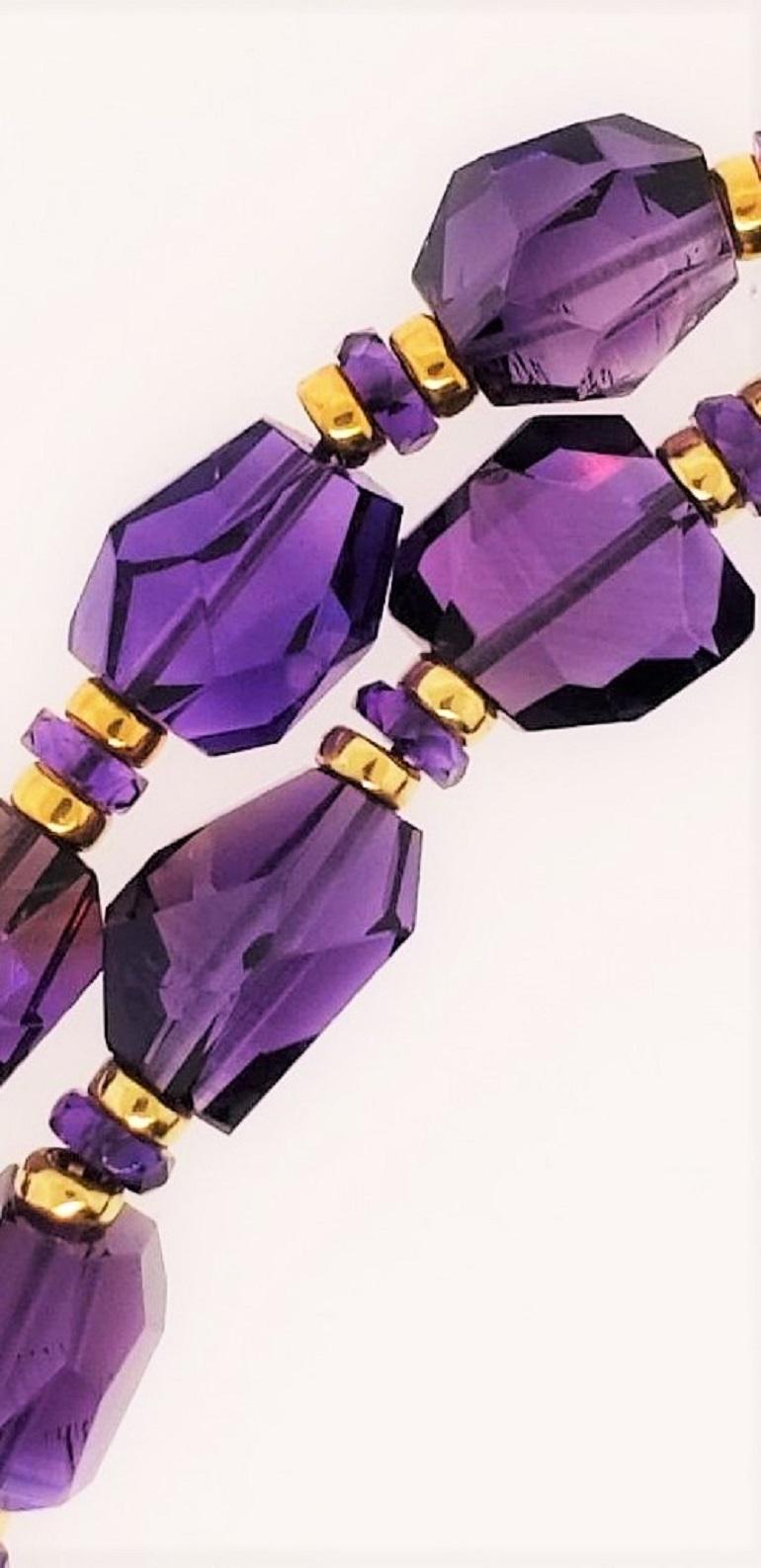 Brought in from our factory in Idar Oberstein Germany, this necklace made of hand cut Amethyst beads is truly beautiful.  Featuring a dark but soothing shade of purple, this necklace's beads are separated by two 18 Karat gold roundels with an