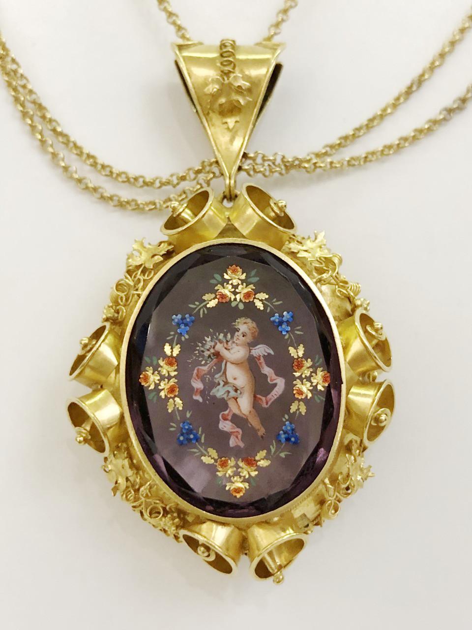 18 karat yellow gold necklace with three strands of chain, and a photo holder pendant with enameled amethyst and engraved with flowers and putto cartouche / Made in Italy 1860-1880s