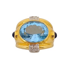 18 Karat Yellow Gold and 12.23 Carat Oval Blue Topaz Ring