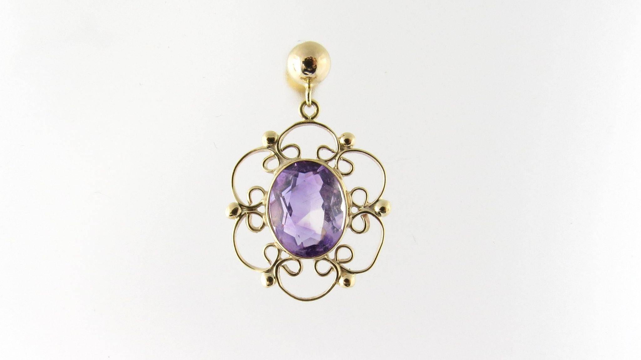 Vintage 18k Yellow Gold and Genuine Amethyst Dangling Earrings 

The center amethysts in these earrings are surrounded by swirls and bows of gold. 

Made for pierced ears, the earrings hang down approximately 28 mm. They are 18 mm across. 

The