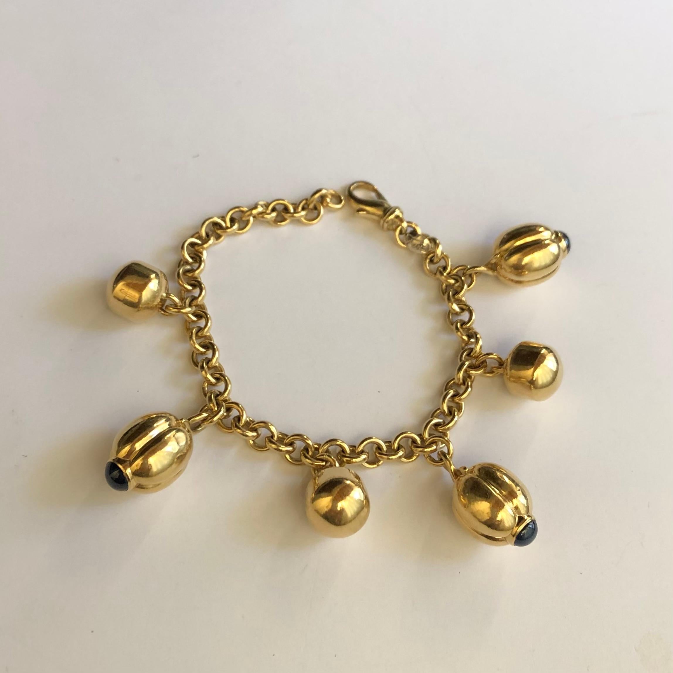 Original 18kt yellow gold with cabochon sapphires FOPE bracelet. 
Six charms in 18kt yellow gold and three of them with cabochon sapphires. Made in Italy. 750 stamp. FOPE logo and manufacturer's stamp: 303 VI ( Vicenza - Italy)
The bracelet is made