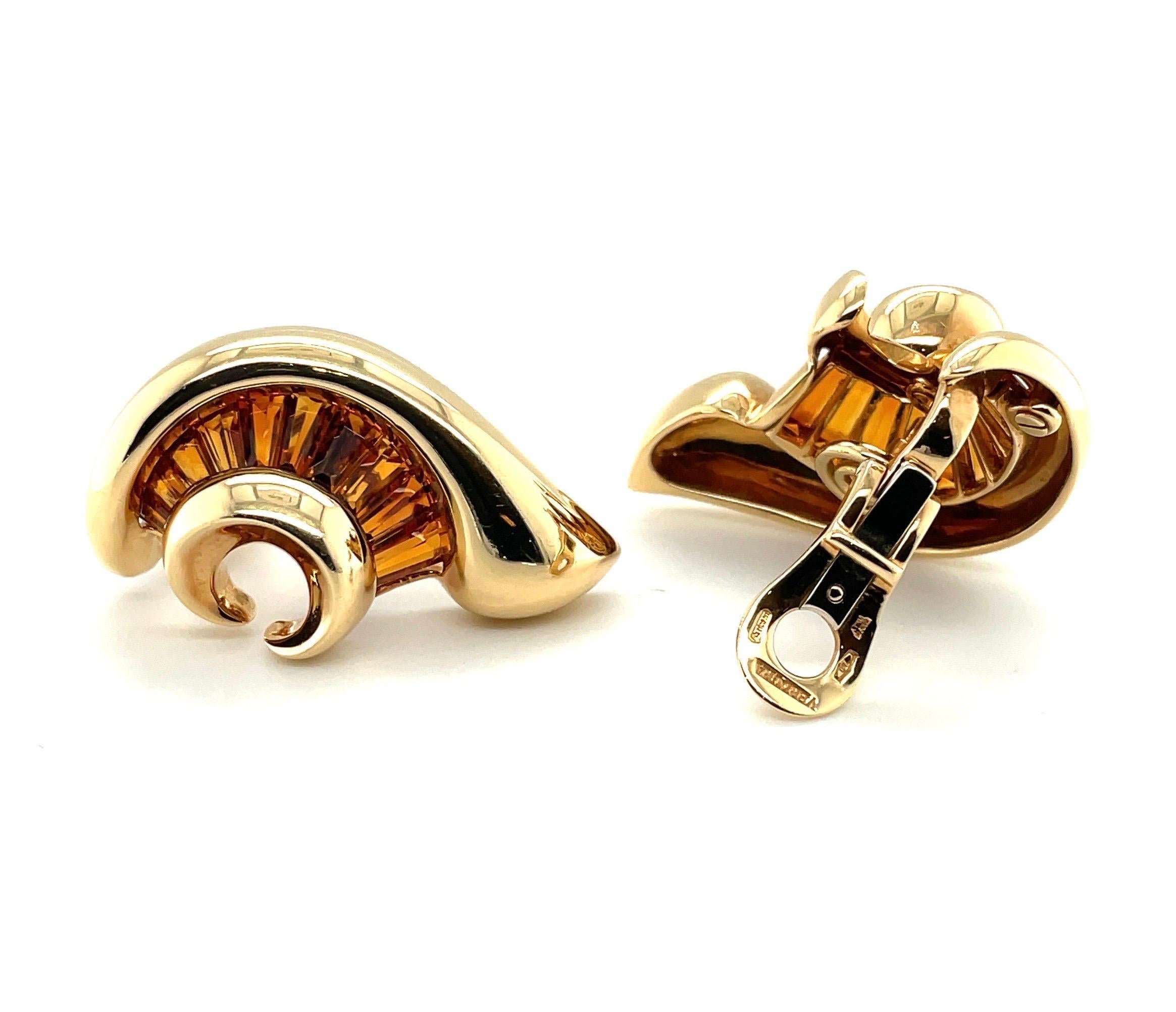Stylish pair of 18 karat yellow gold and citrine ear clips by Verdura. 

Eye-catching 18 karat yellow gold ear clips of slightly bombé design, each in form of a stylised shell and decorated with 10 calibré-cut, trapeze-shaped citrines. These