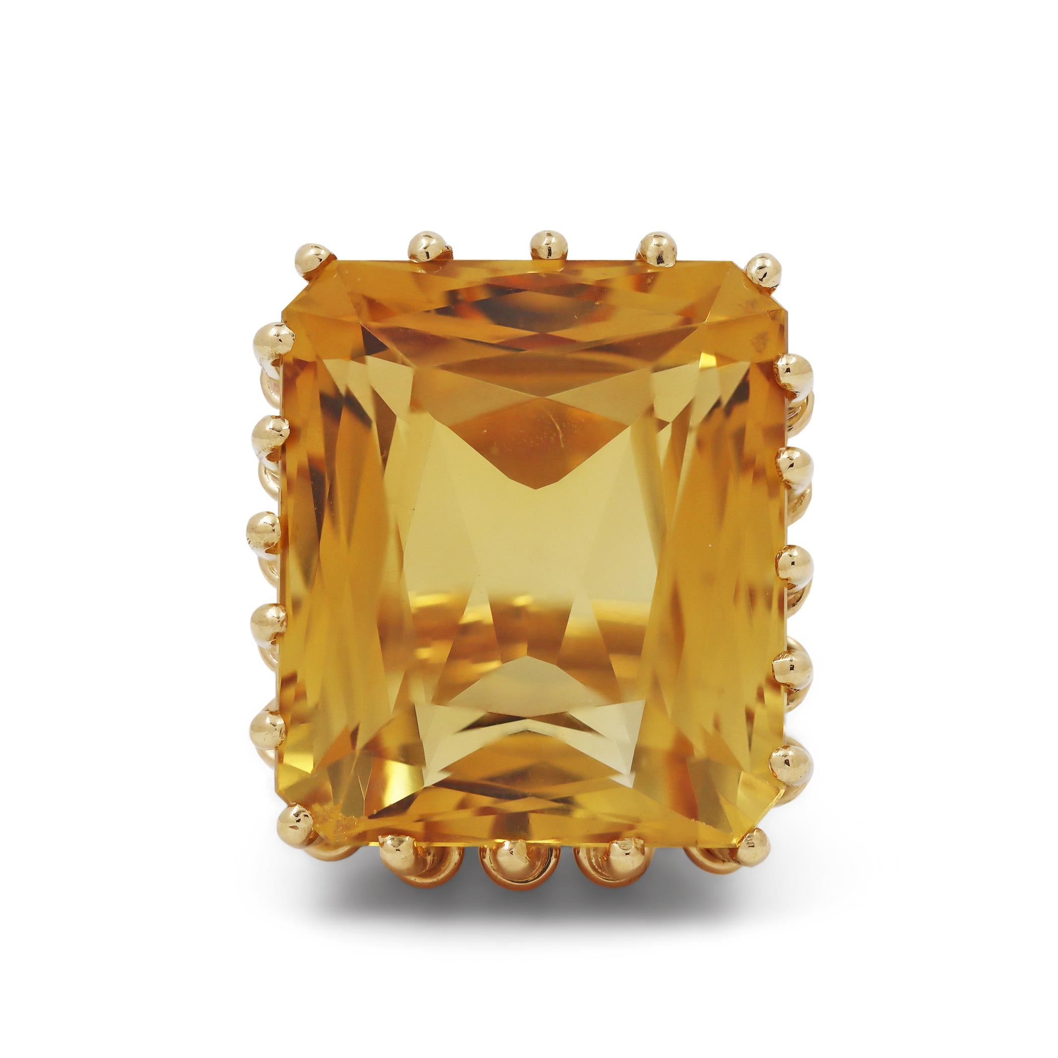 Make a statement with this striking cocktail ring. A uniquely designed 18 karat yellow gold basket setting boldly embraces an orangey-yellow rectangular faceted citrine of approximately 38 carats and measuring 22.9mm x 19.7mm.  US size 7.  The ring