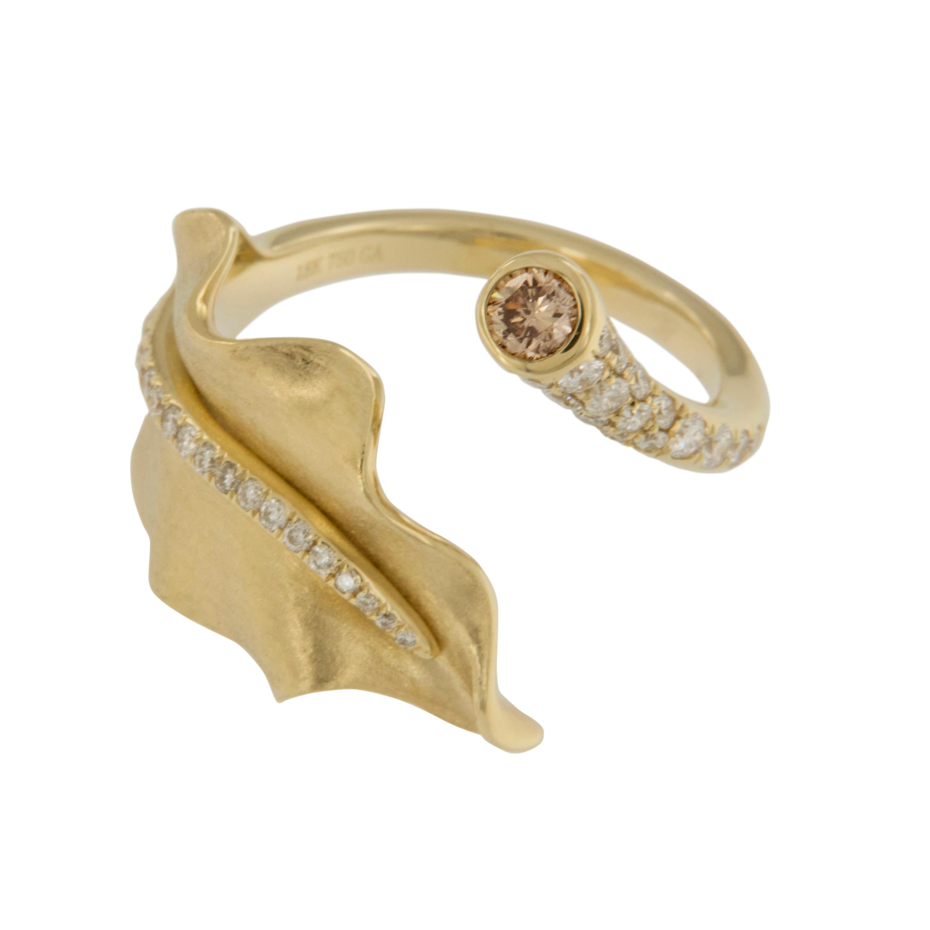You can almost feel the warm, crisp air & subtle rustle of a perfect fall day when looking at this stunning, ethereal leaf motif ring. Fine details like the satin fabric texture of the 18 karat yellow gold undulating leaf perfectly set off with a