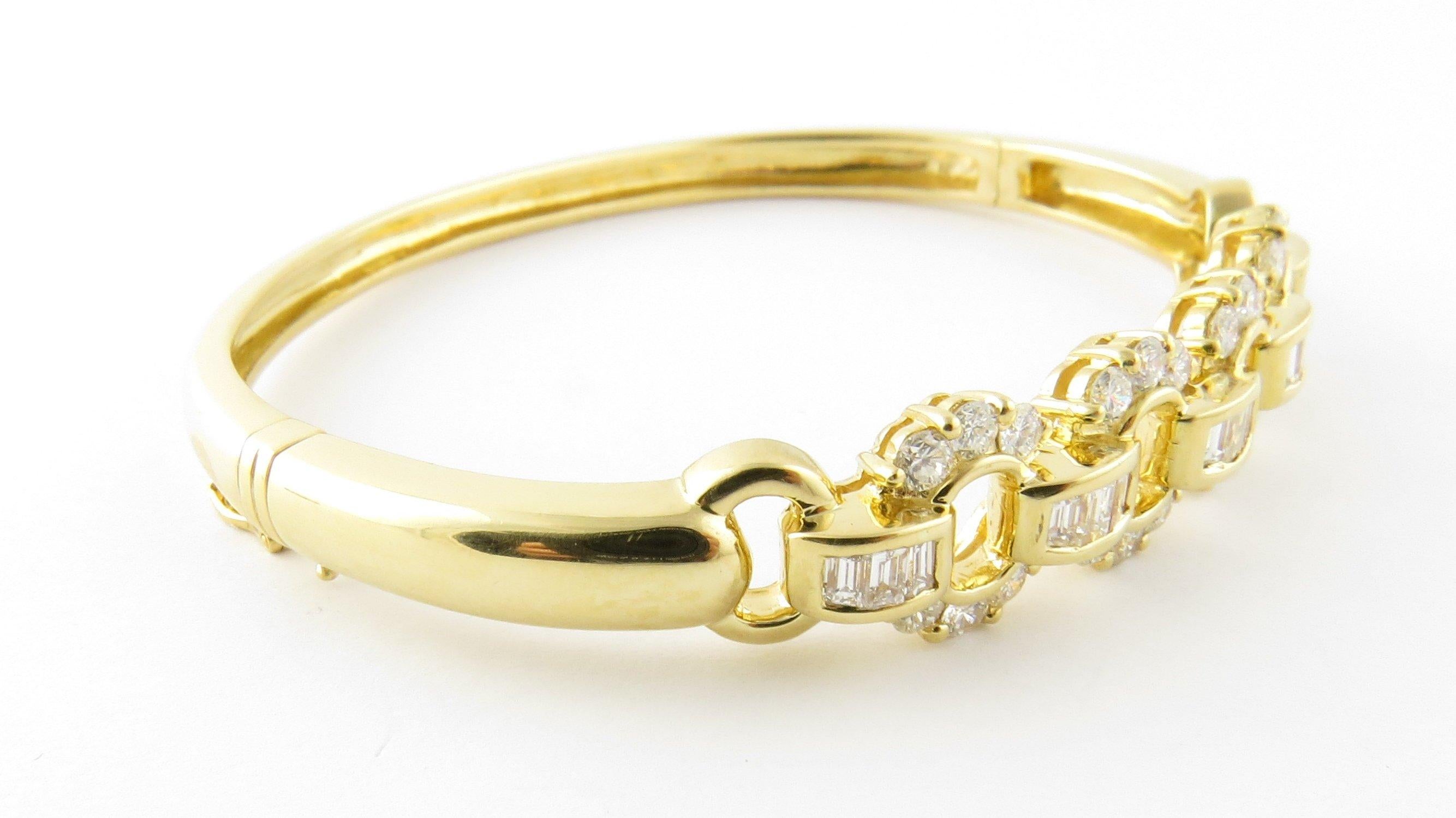 Vintage 18 Karat Yellow Gold and Diamond Bangle Bracelet- This stunning hinged bangle bracelet features 24 round brilliant cut diamonds (.04 ct. each) and 15 baguette diamonds (.65 ct. twt.) set in polished 18K yellow gold. Width at widest point: 11