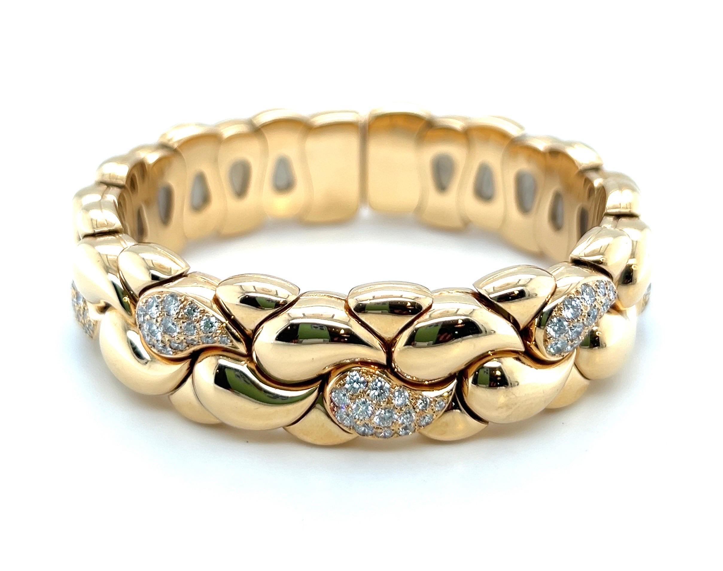 Striking 18 karat yellow gold and diamond Casmir bangle by renowned Swiss tradition jeweler Chopard.

Flexible bangle, designed as a series of slightly bombé, gold paisley links, seven of which are pavé-set with brilliant-cut diamonds totalling