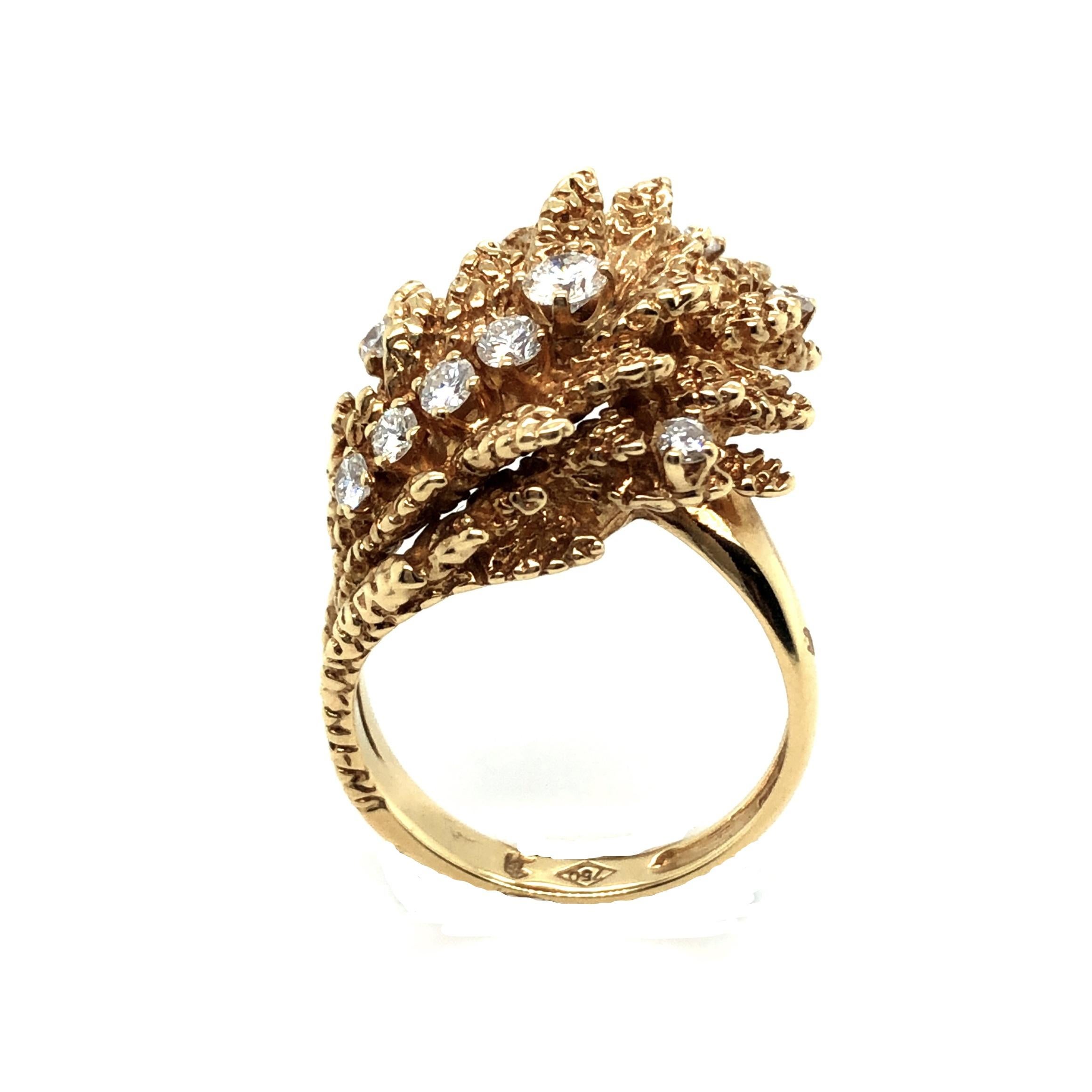 Ravishing 18 karat yellow gold and diamond dress/cocktail ring, circa 1970.
Of abstract asymmetric floral design, the textured gold leaves highlighted with 10 brilliant-cut diamonds totalling circa 0.5 carats.
This jewel is in very good vintage
