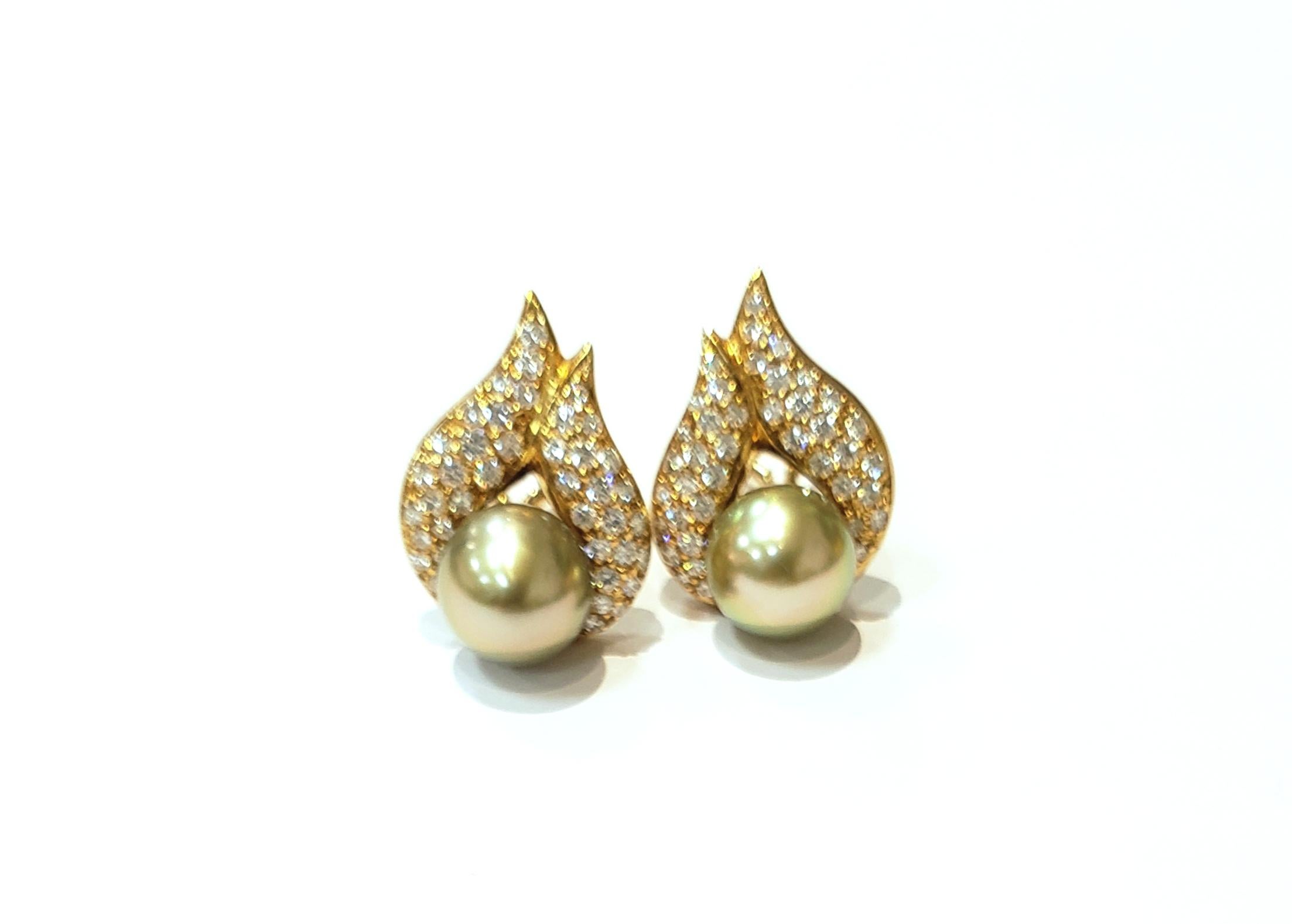 18 karat yellow gold & diamond earrings, each containing a 9mm pistachio pearl. Pave set, full cut diamonds = 1.30 carats
Earrings are clip on style , with a french clip. Pearls are set in bottom center of earring, with a flame of diamonds.
Pearls