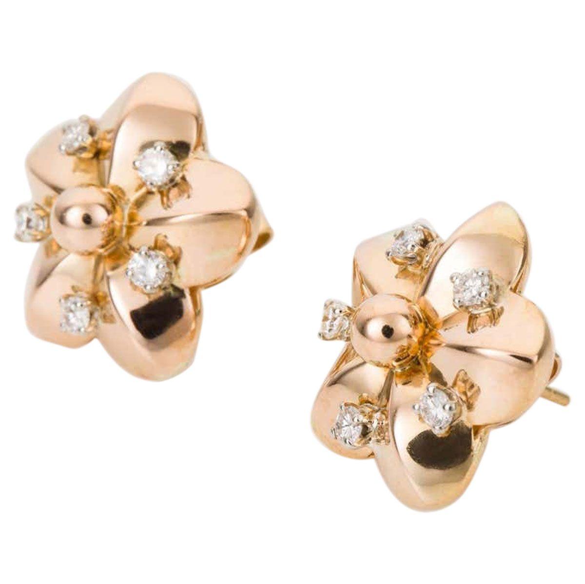 Flowers for your ears! These perfectly pretty 18k yellow gold and diamond earrings sit beautifully on the ears and give a wonderful show. If you love flowers, and who doesn't then these earrings will make you smile. 
Designed as an open style flower