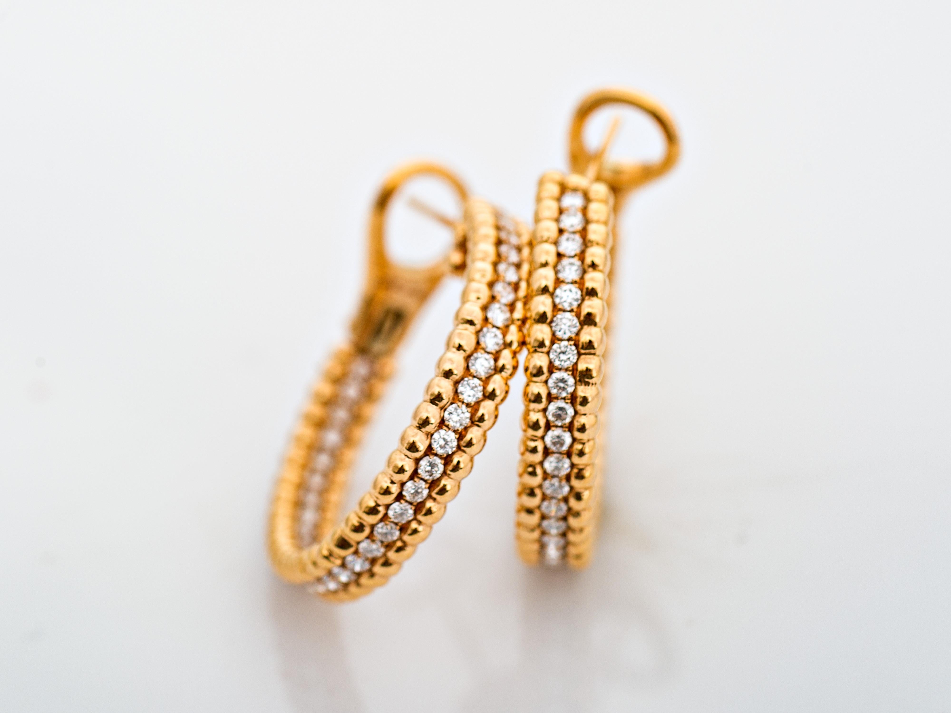 Rose gold hoops embellished in a single line of brilliant shaped diamonds along front curve and in the back of the inside curve, allowing the piece to shine at all times.