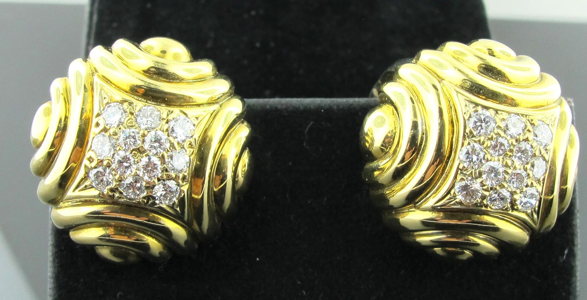 Set in 18 karat yellow gold are 24 round brilliant cut diamonds, 12 diamonds in each earring.  The diamond weight is 0.75 total.  Color is G, Clarity is VS.  23 grams of gold in a nice swirl design. French Clips. 