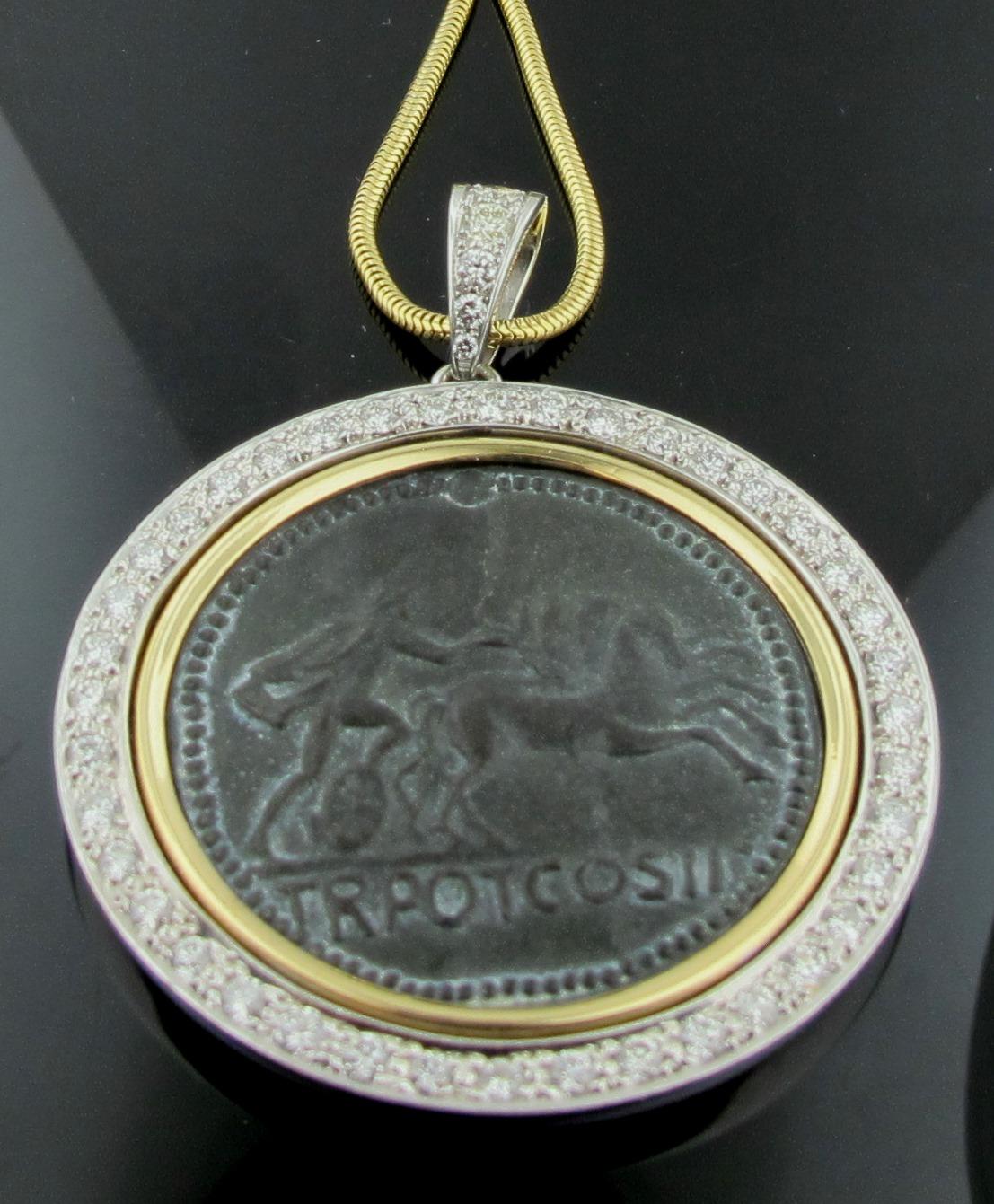 Set in 18 karat yellow gold is a Roman Coin surrounded with 40 round brilliant cut diamonds for a total diamond weight of 2.00 carats, plus 5 round brilliant cut diamonds in the bale for a total weight of 0.50 carats.  Total diamond weight is 2.50
