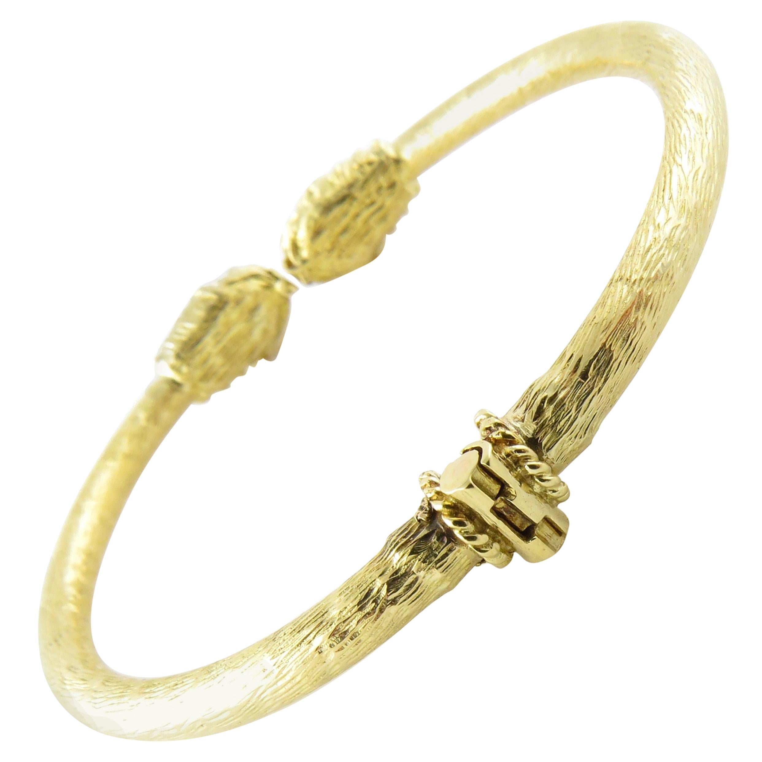Vintage 18 Karat Yellow Gold and Diamond Serpent Head Bangle Bracelet- 
This spectacular hinged bangle bracelet features two serpent heads accented with four rose cut diamonds. 
Exquisitely crafted in 18K yellow gold.
 Bracelet width: 4 mm.