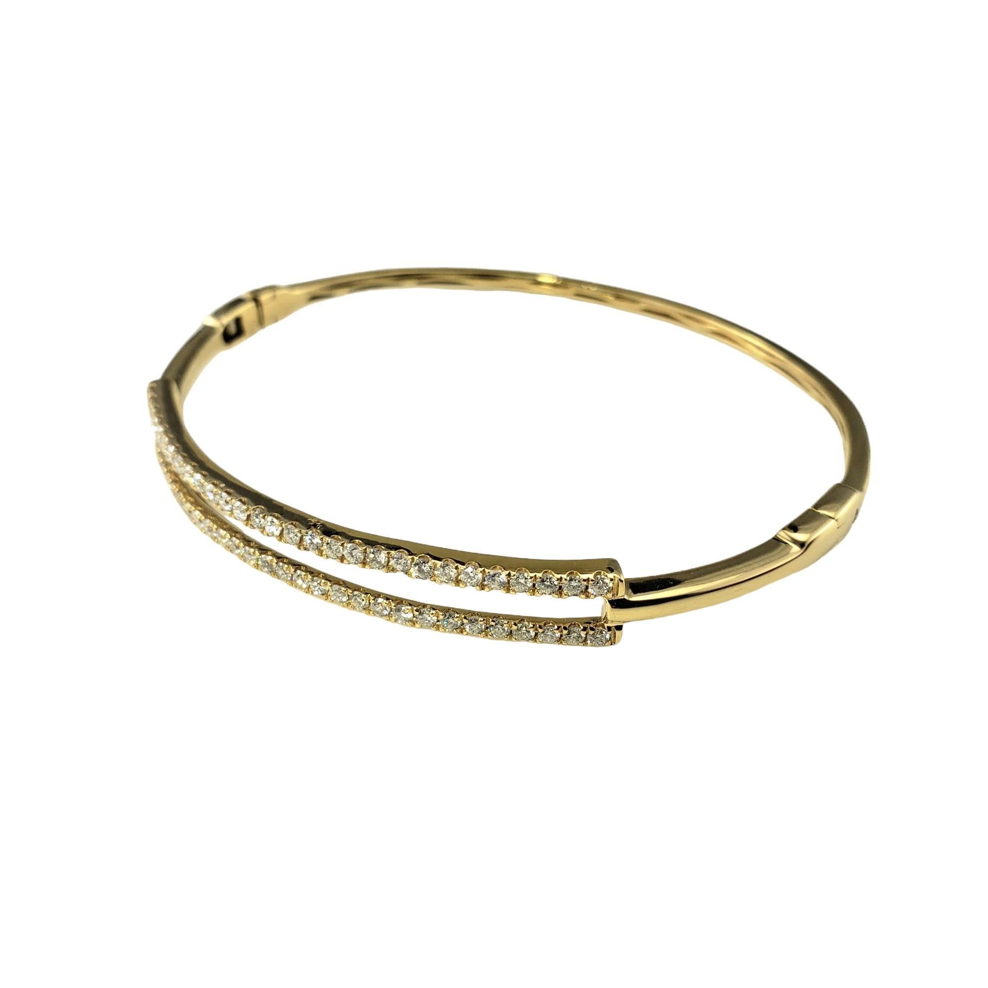 18 Karat Yellow Gold and Diamond Bangle Bracelet

This sparkling bangle bracelet features 58 round brilliant cut diamonds set in beautifully detailed 18K yellow gold. Hinged closure.

Width: 6 mm.

Approximate total diamond weight: .60 ct.

Diamond