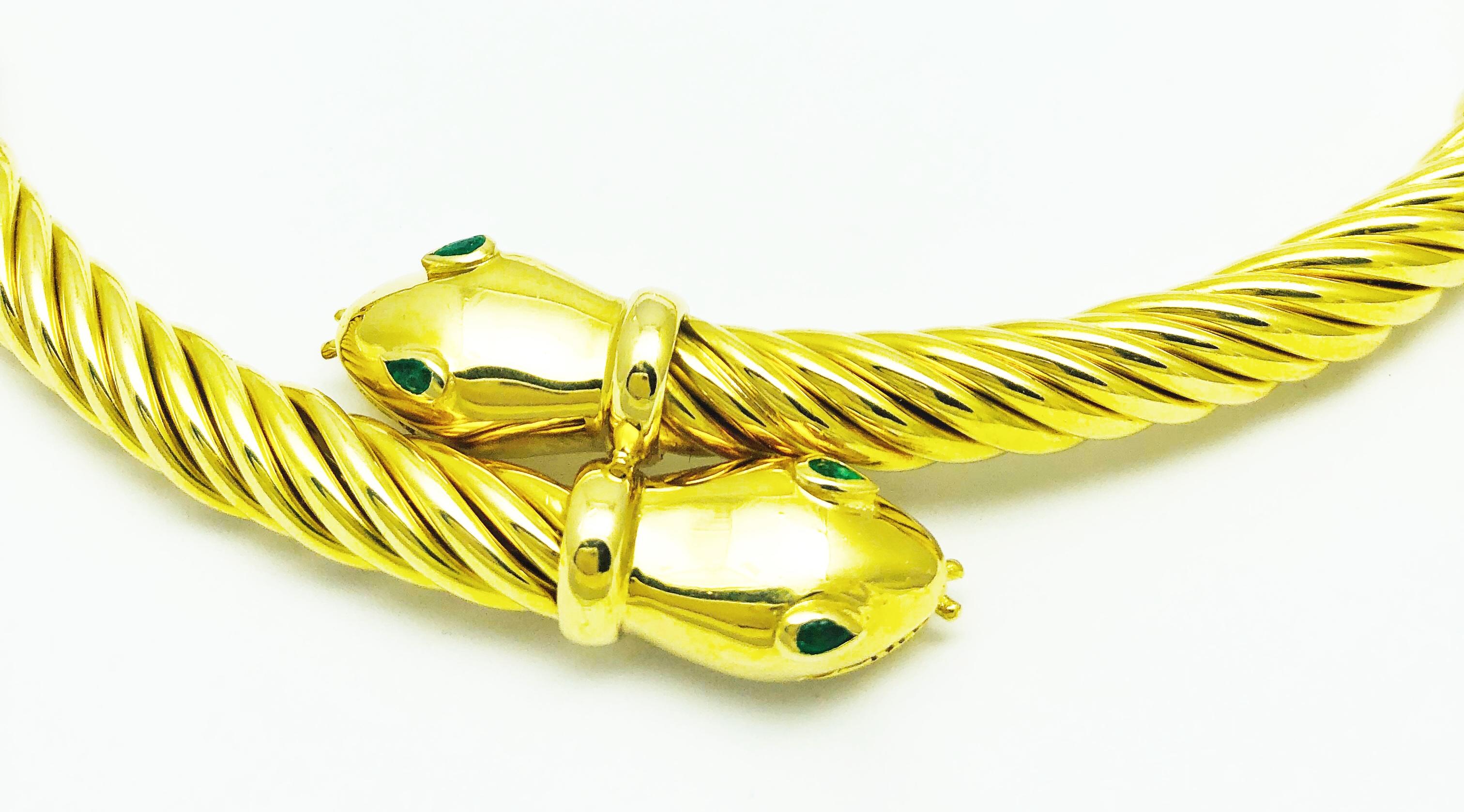 This is an absolutely Stunning Necklace! Made in 18K Yellow Gold, this double headed snake necklace is an 8mm cable link that is 17 inches long and measures 135.1 grams. The snakes eyes are pear shaped emeralds. This very unique piece has beautiful