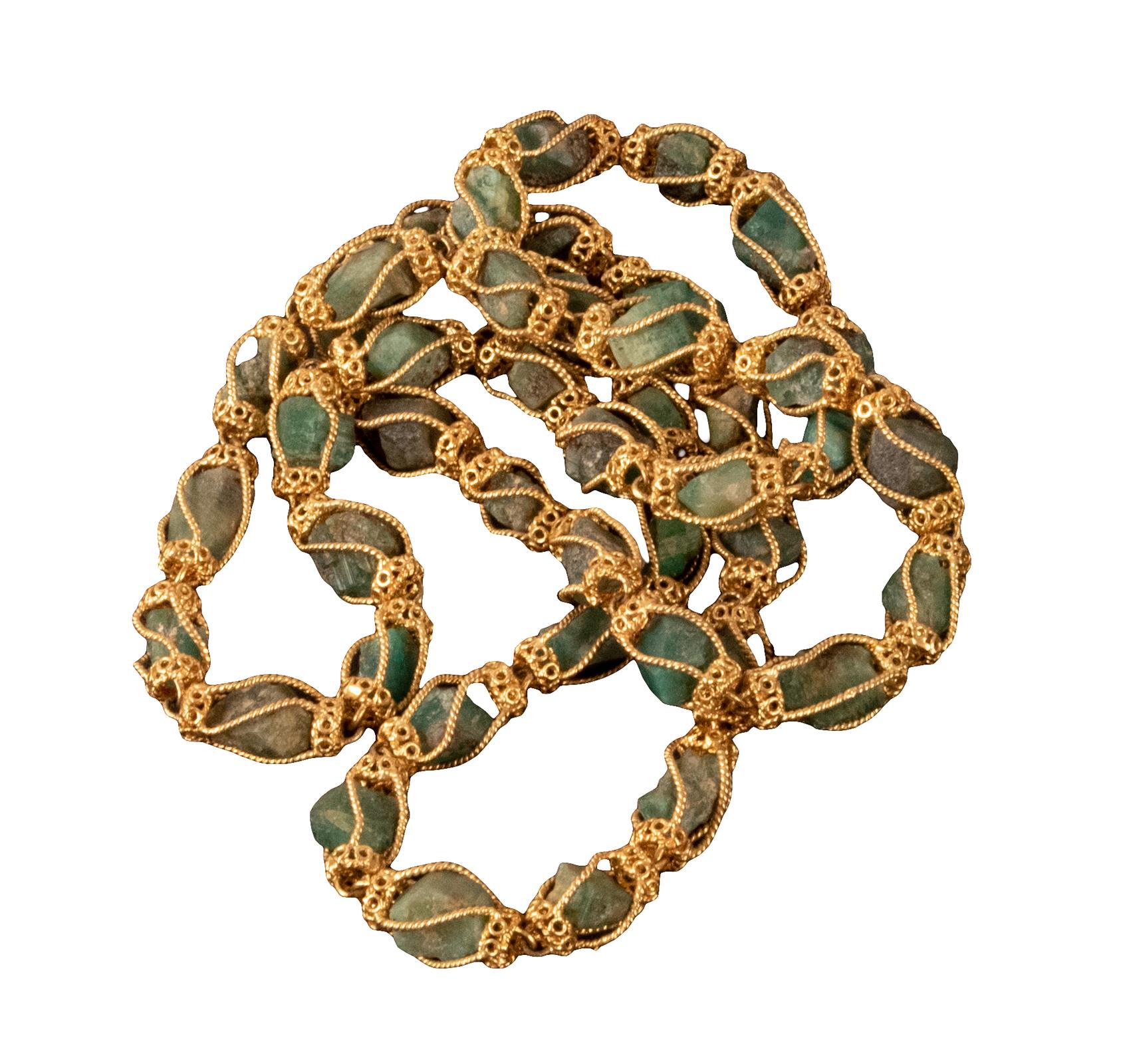 Comprised of forty-four 18-karat yellow gold filigree-caged raw emerald crystal beads. Total length: 34.5 in. / 87.5 cm. Estimated to contain approximately 1.50 ozt of pure gold.

DWT 82.1.